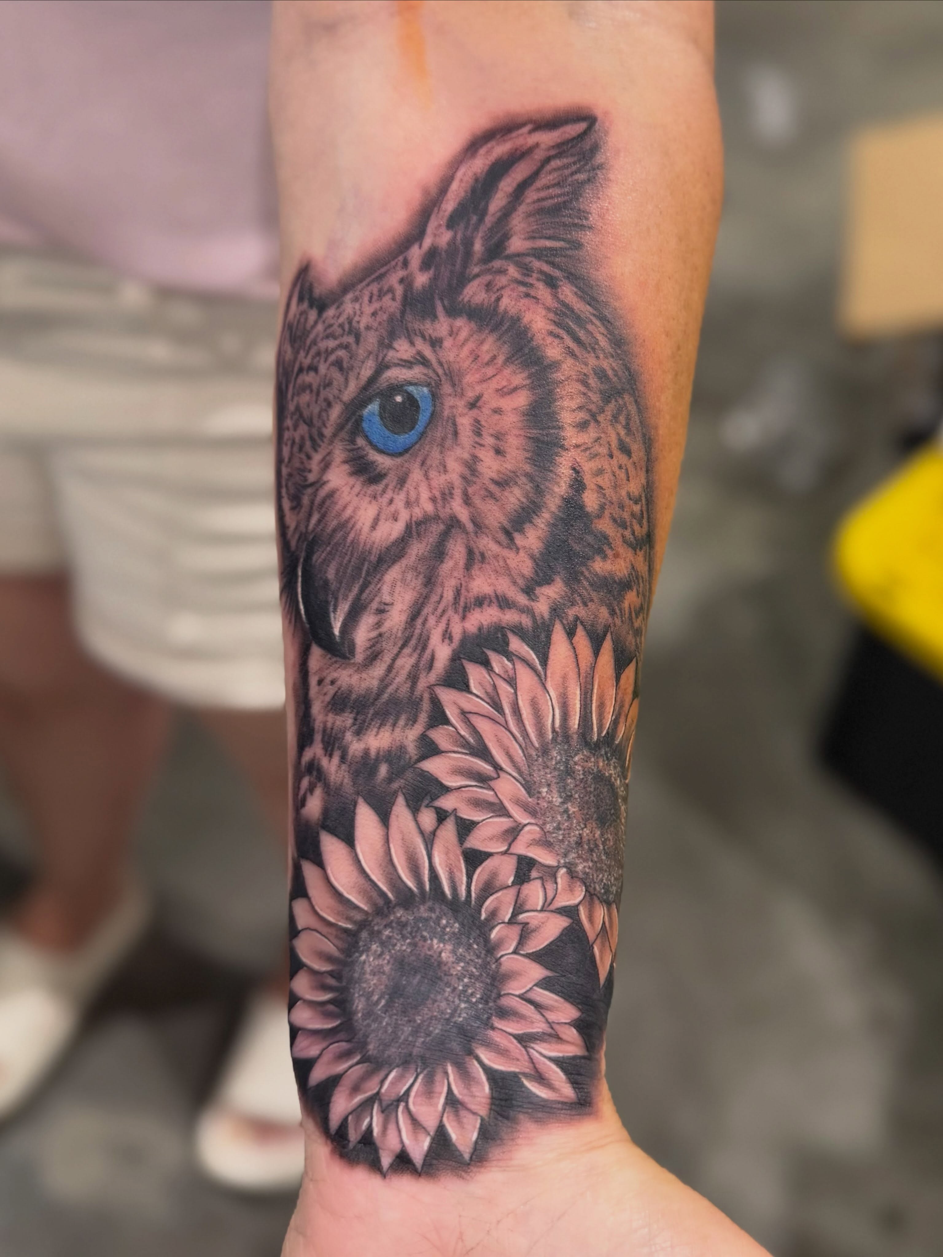Owl and sunflowers realism tattoo on the forearm by Zeninkz