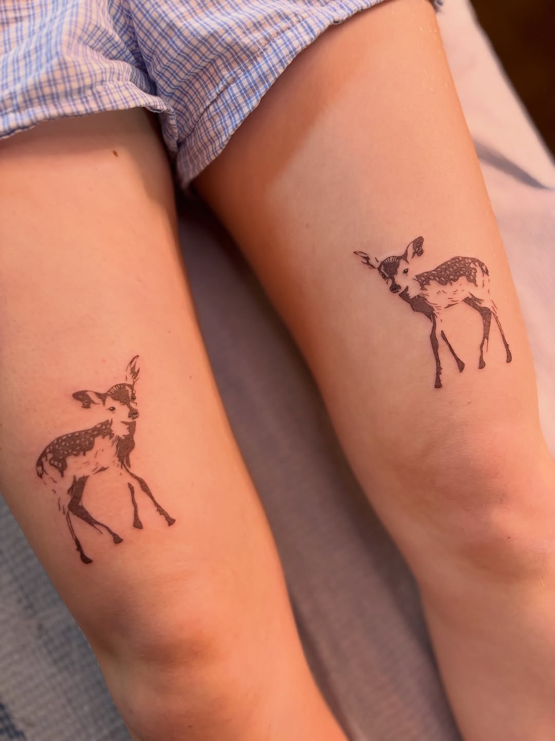Two fawns fine line tattoo on the forearm by Olivia D’Amore
