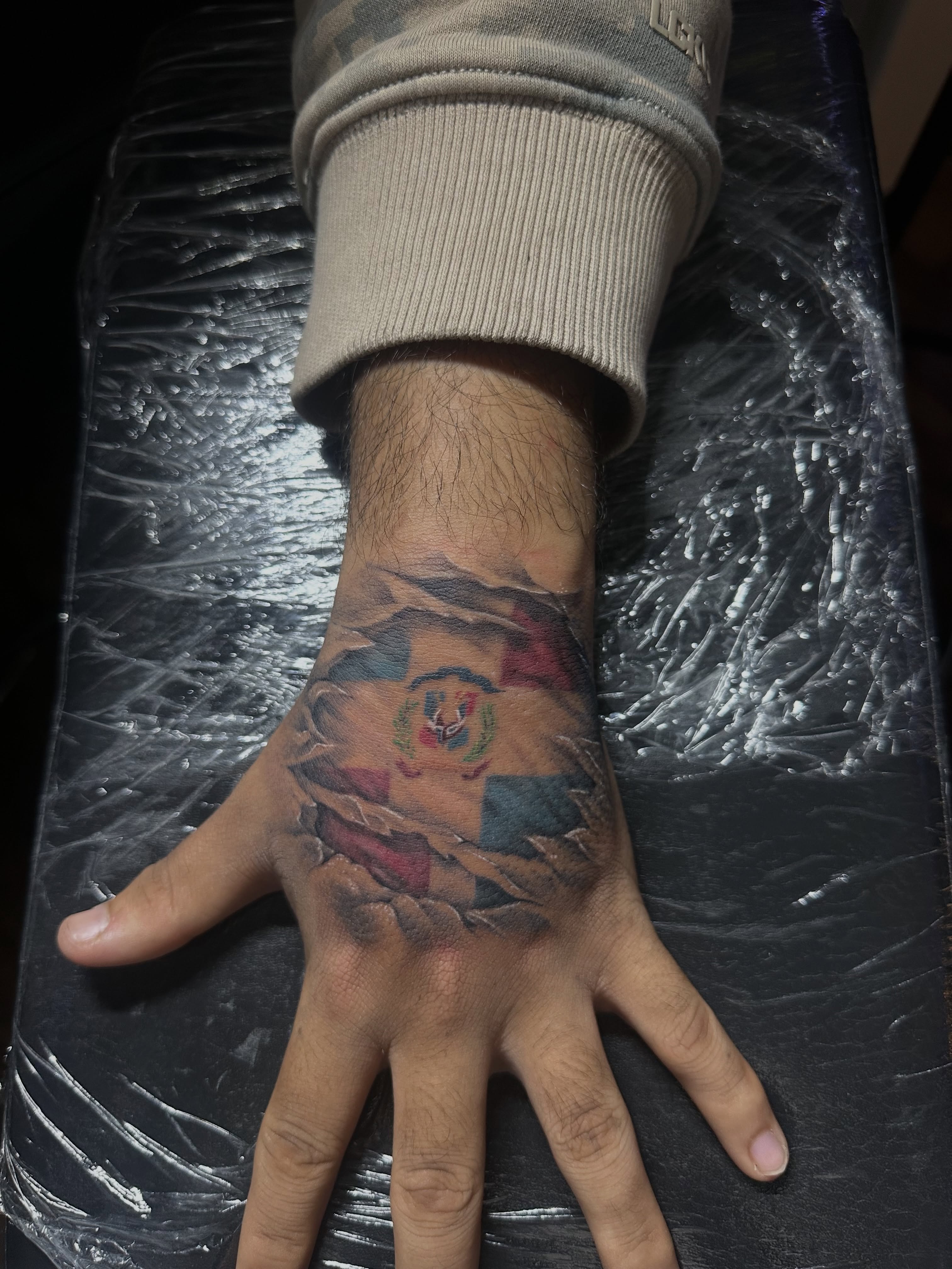 Flag and map realism tattoo on the hand by Chris (Pikasso)