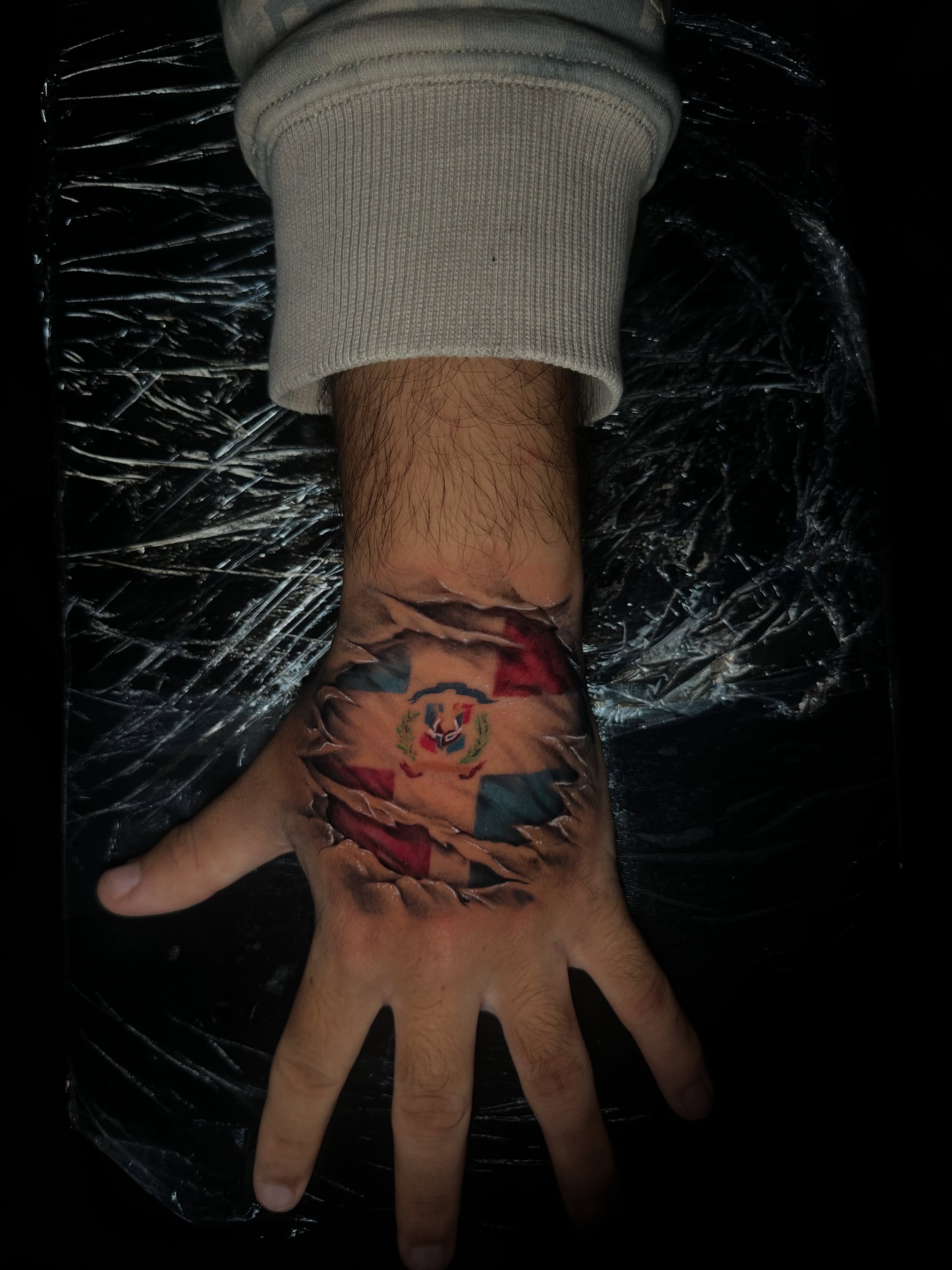Flag realism tattoo on the hand by Chris (Pikasso)
