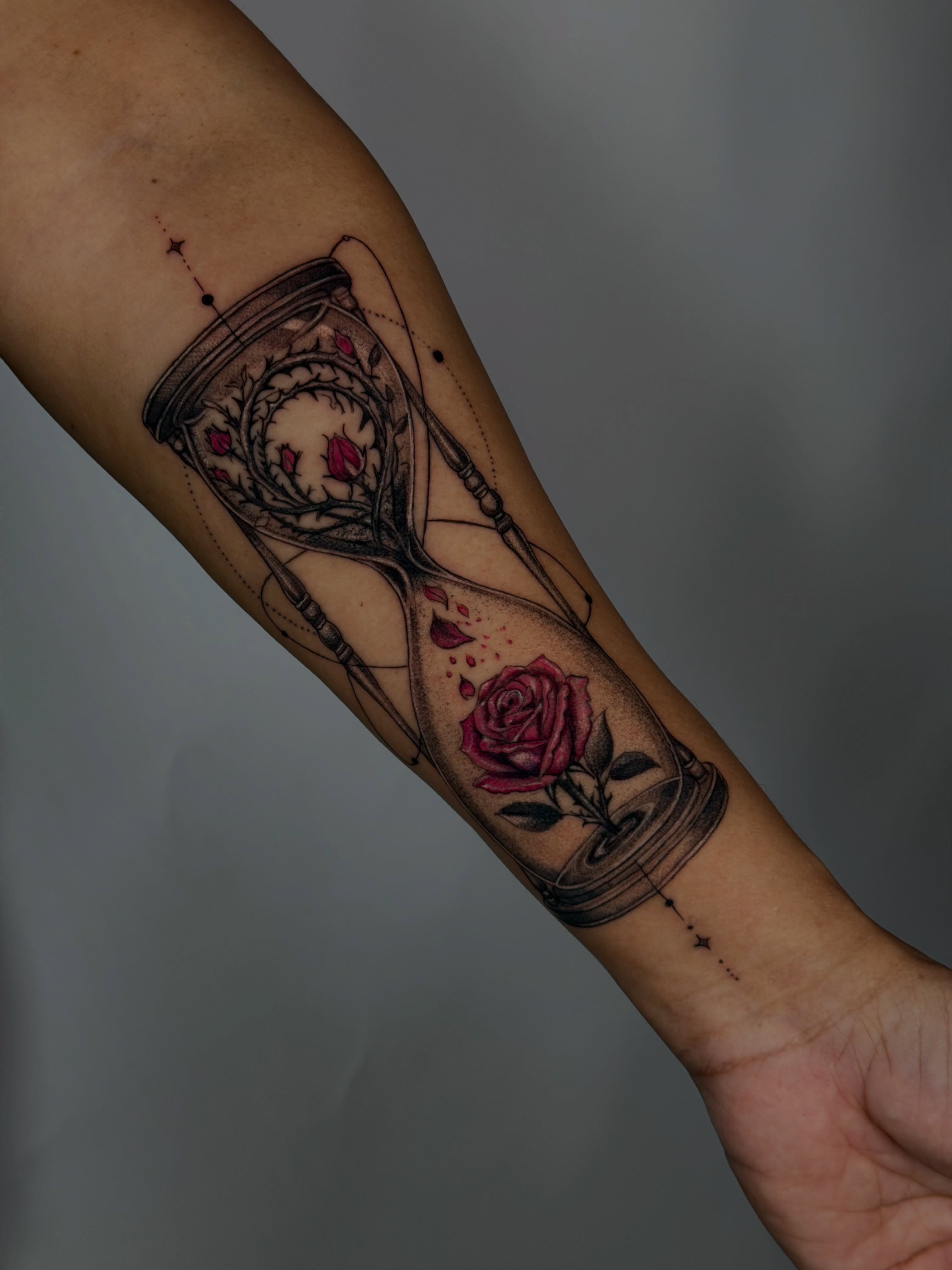 Hourglass and rose realism tattoo on the forearm by Fabian Hellberg