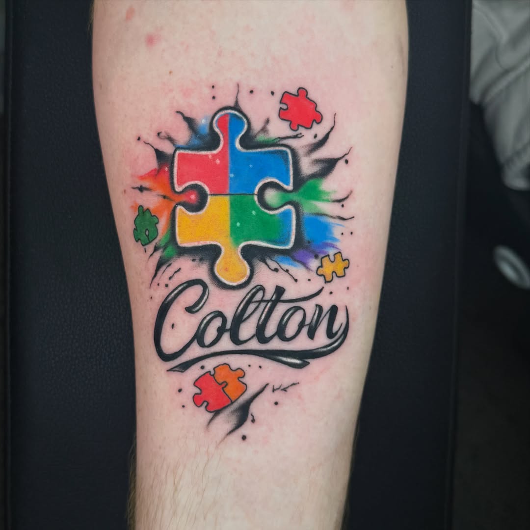 Jigsaw puzzle watercolor tattoo on the forearm by Tevin Thomas