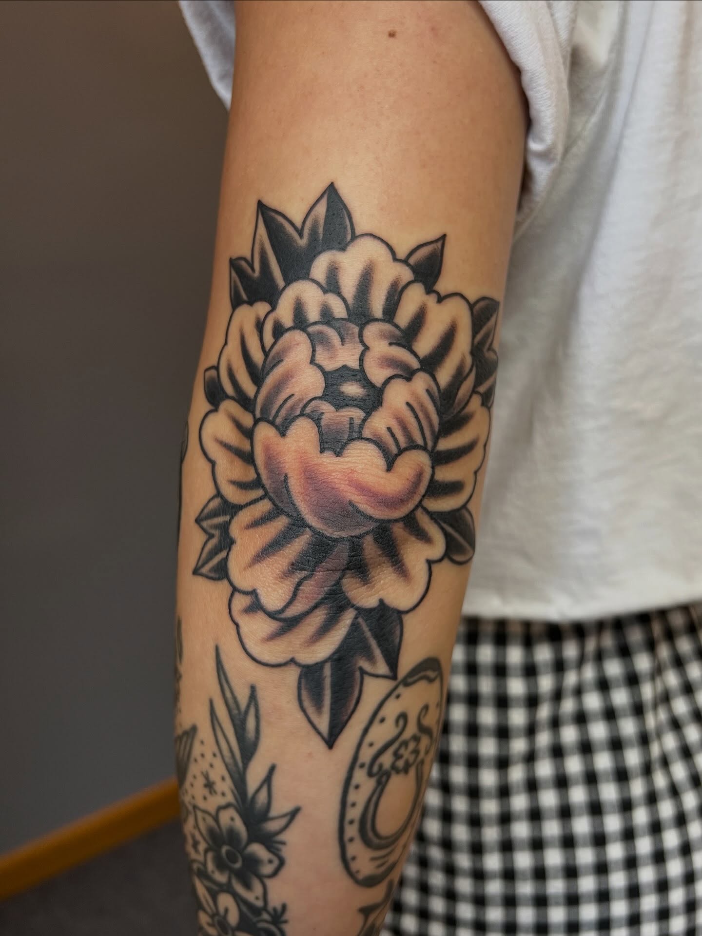 Peony American traditional tattoo on the forearm by Tyler Van Pelt