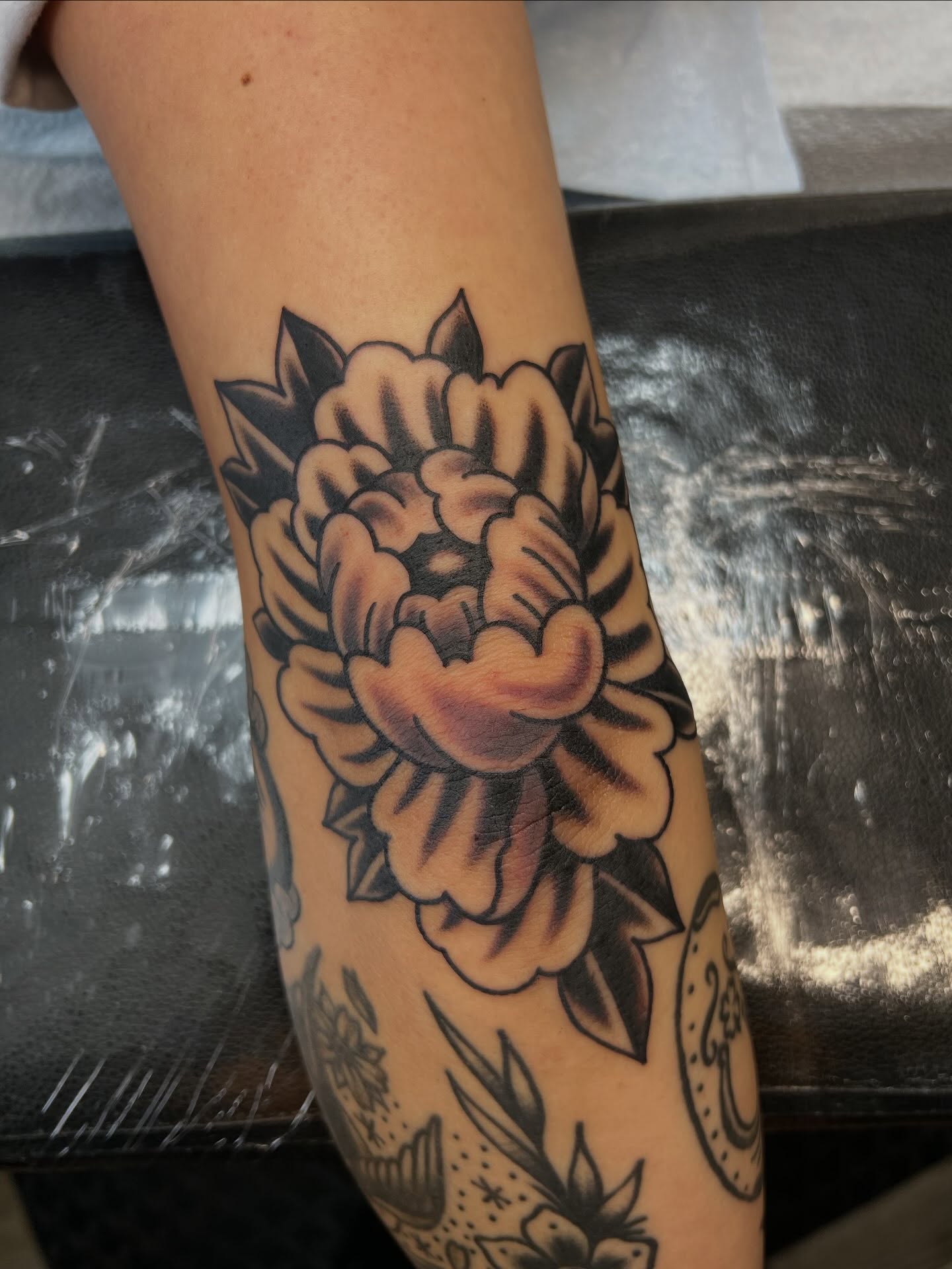 Peony American traditional tattoo on the forearm by Tyler Van Pelt