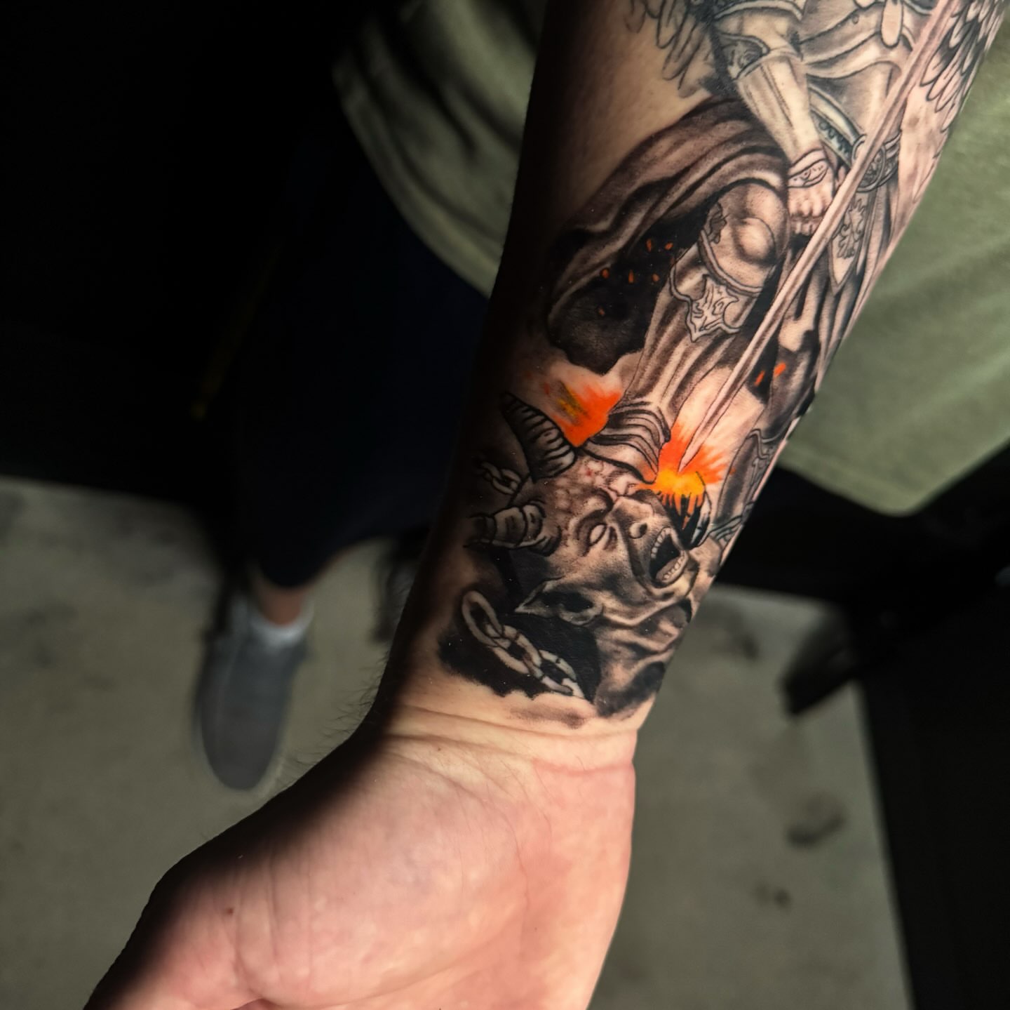 Warrior and dragon realism tattoo on the forearm by Brandiane Wells