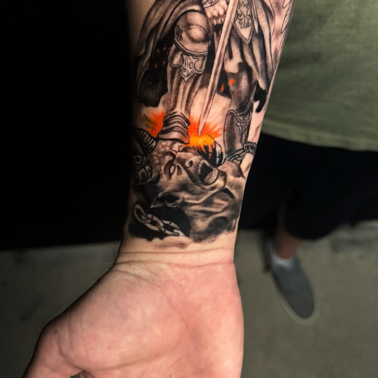 Warrior slaying dragon realism tattoo on the forearm by Brandiane Wells