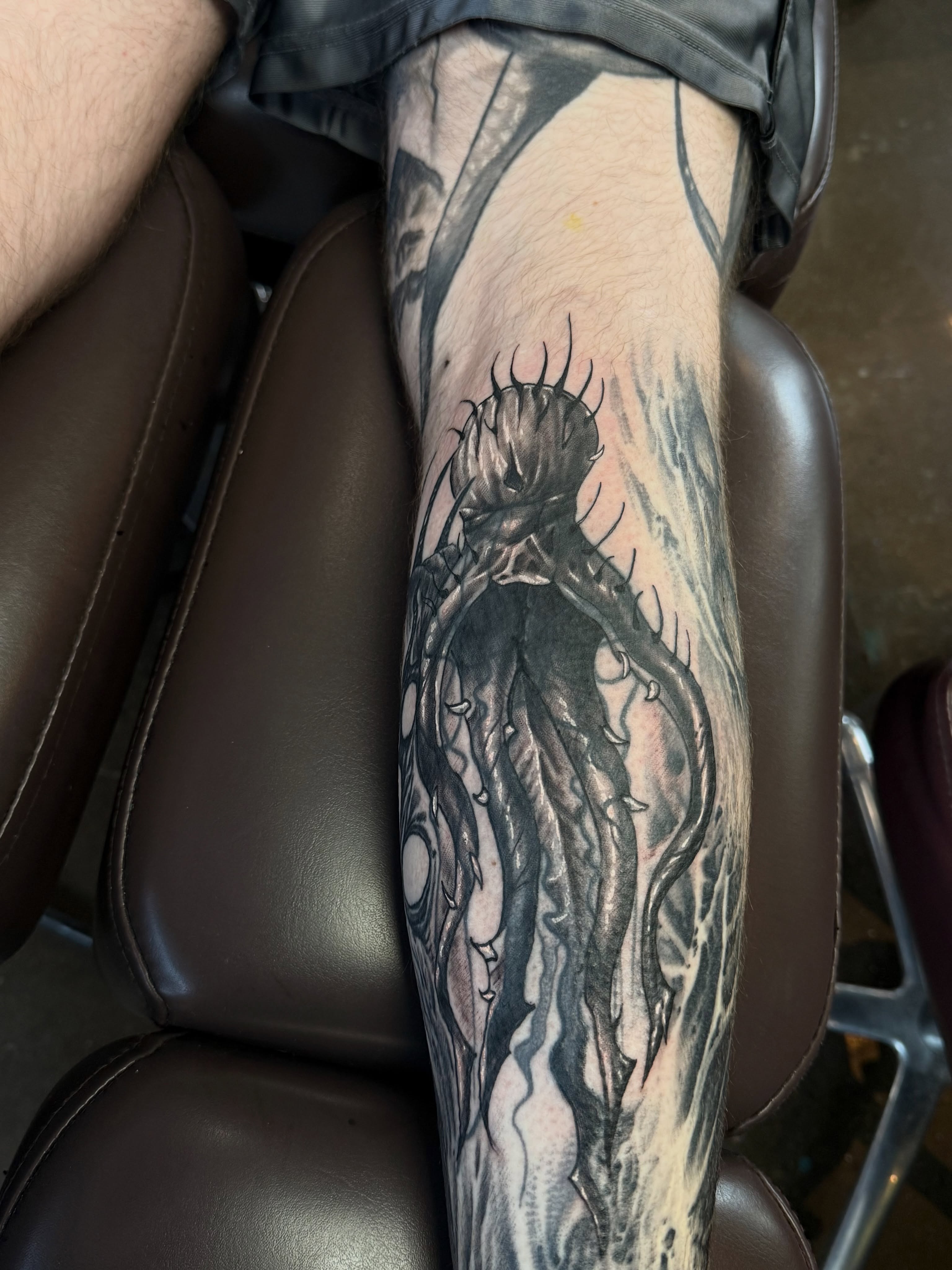 Tentacle monster dark realism tattoo on the forearm by Miles Haysmith
