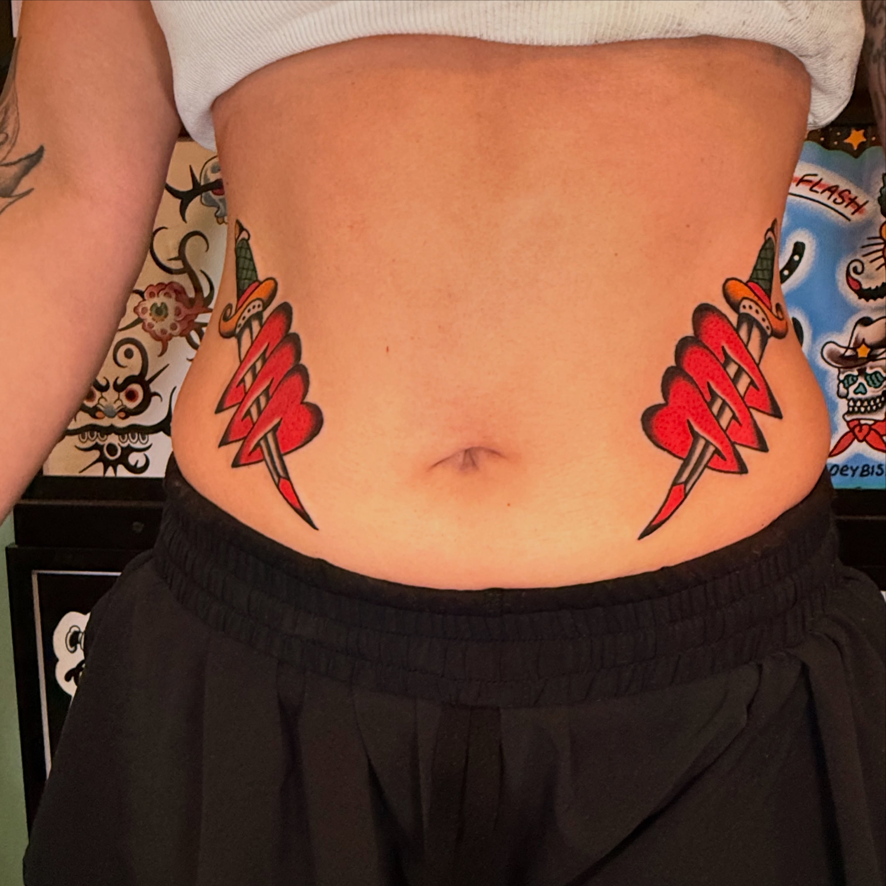Lightning bolts American traditional tattoo on the torso by {{Theo Glanton}}