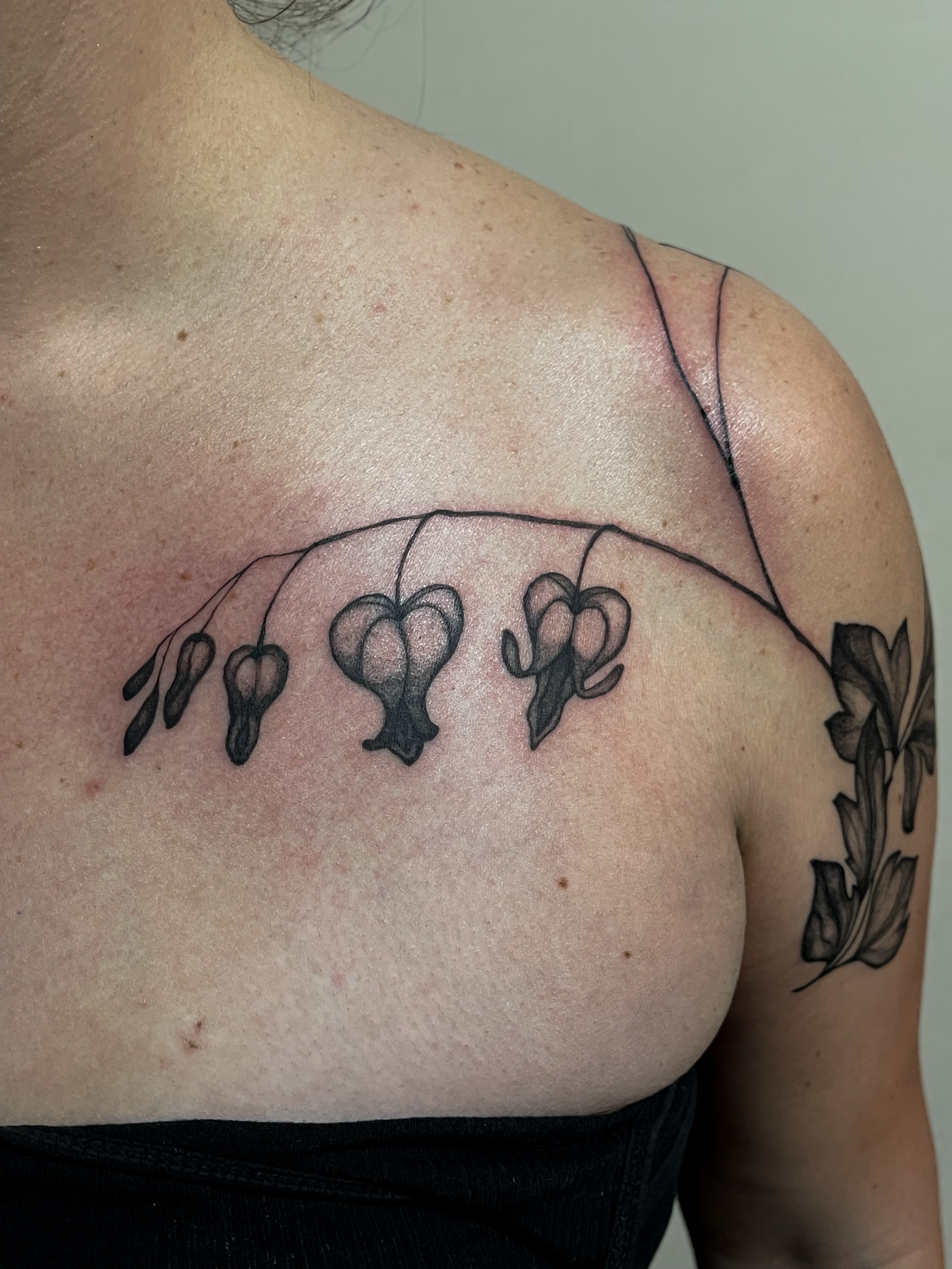 Flower cluster black and grey tattoo on the shoulder by Amy