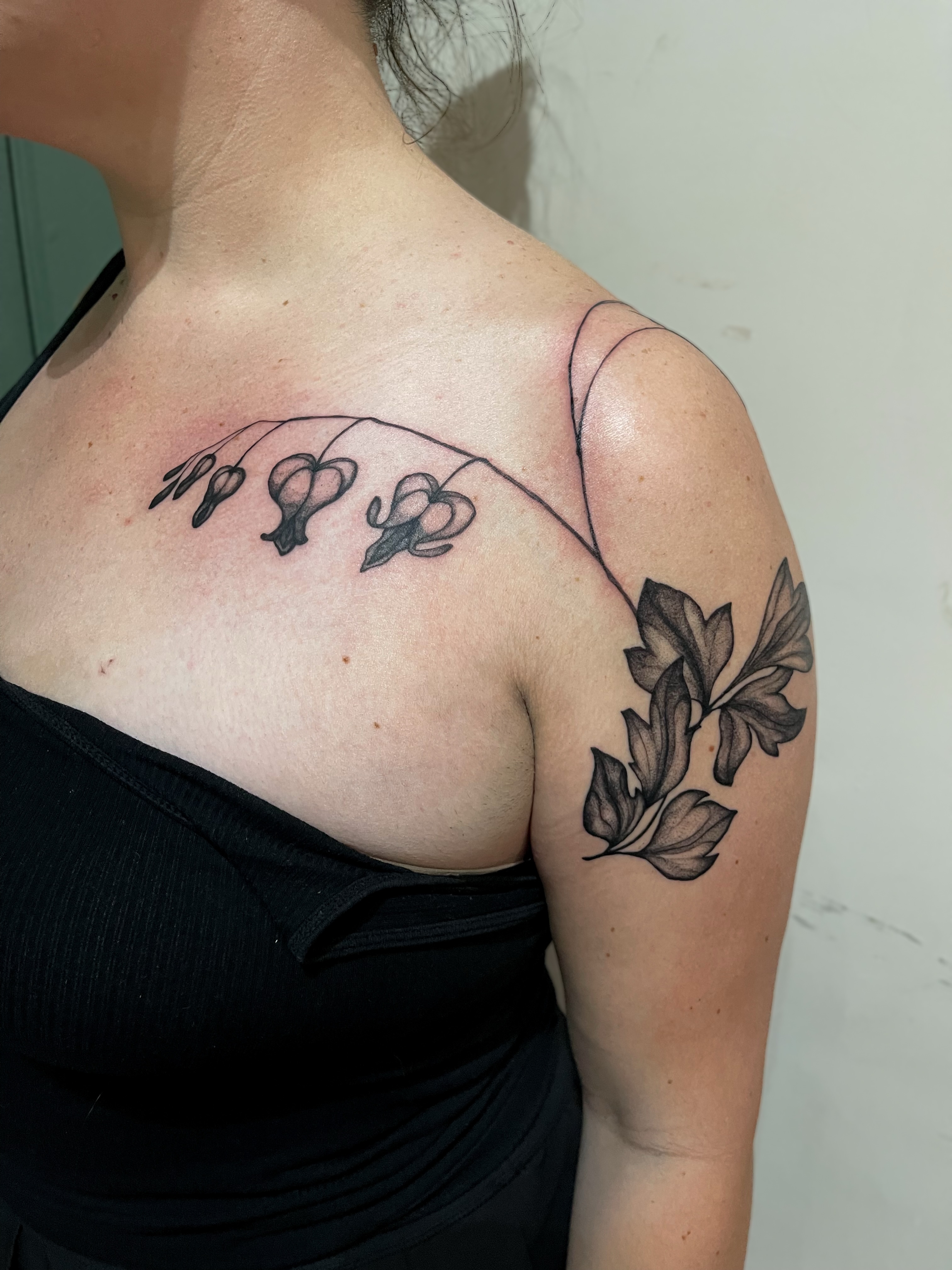 Flowers black and grey tattoo on the shoulder by Amy