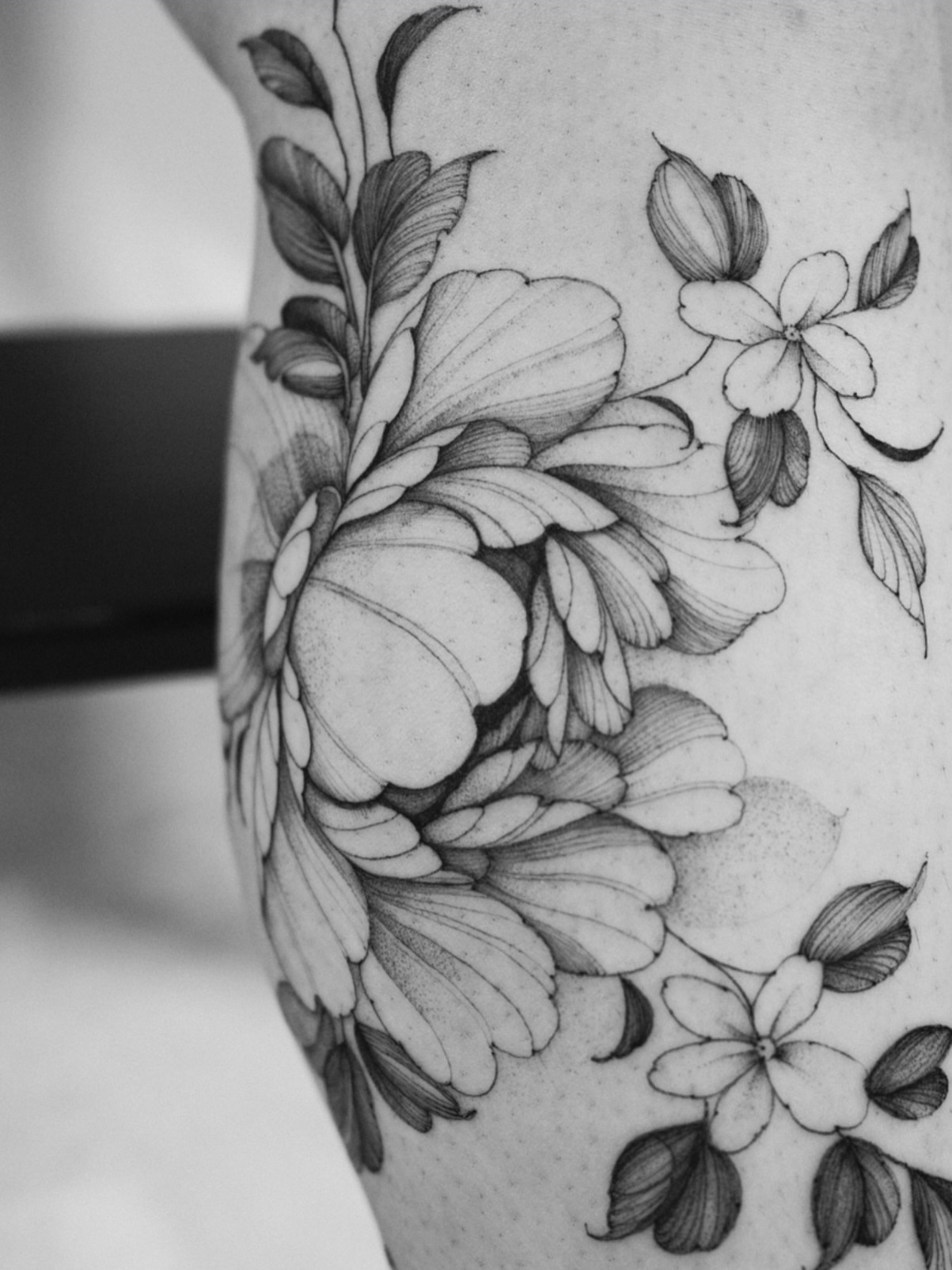 Floral arrangement black and grey tattoo on the upper arm by LORIE π€ Floral Tattoo Artist, Los Angeles, California