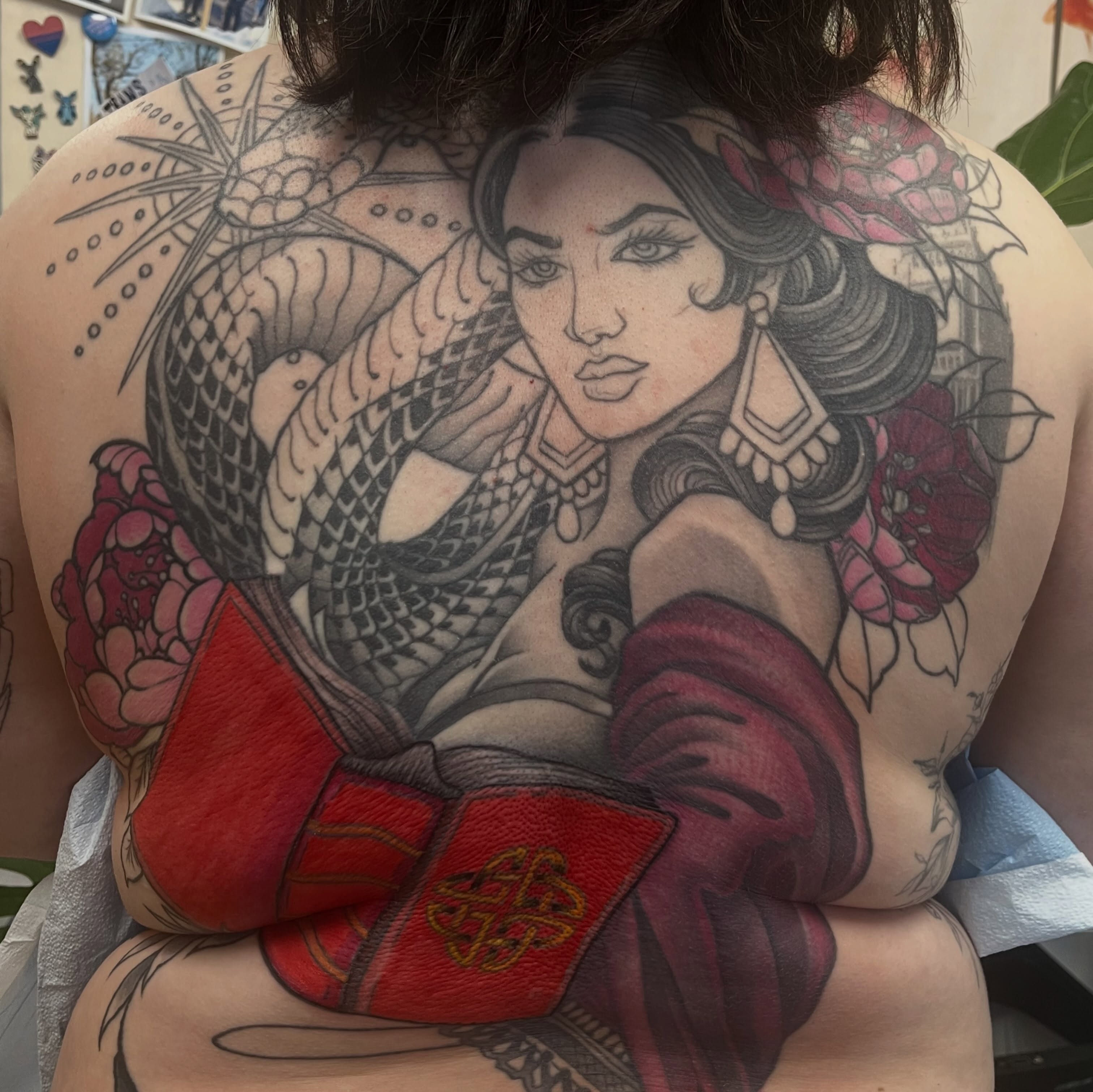 Mermaid reading book American traditional tattoo on the back by Garden Glow Tattoo