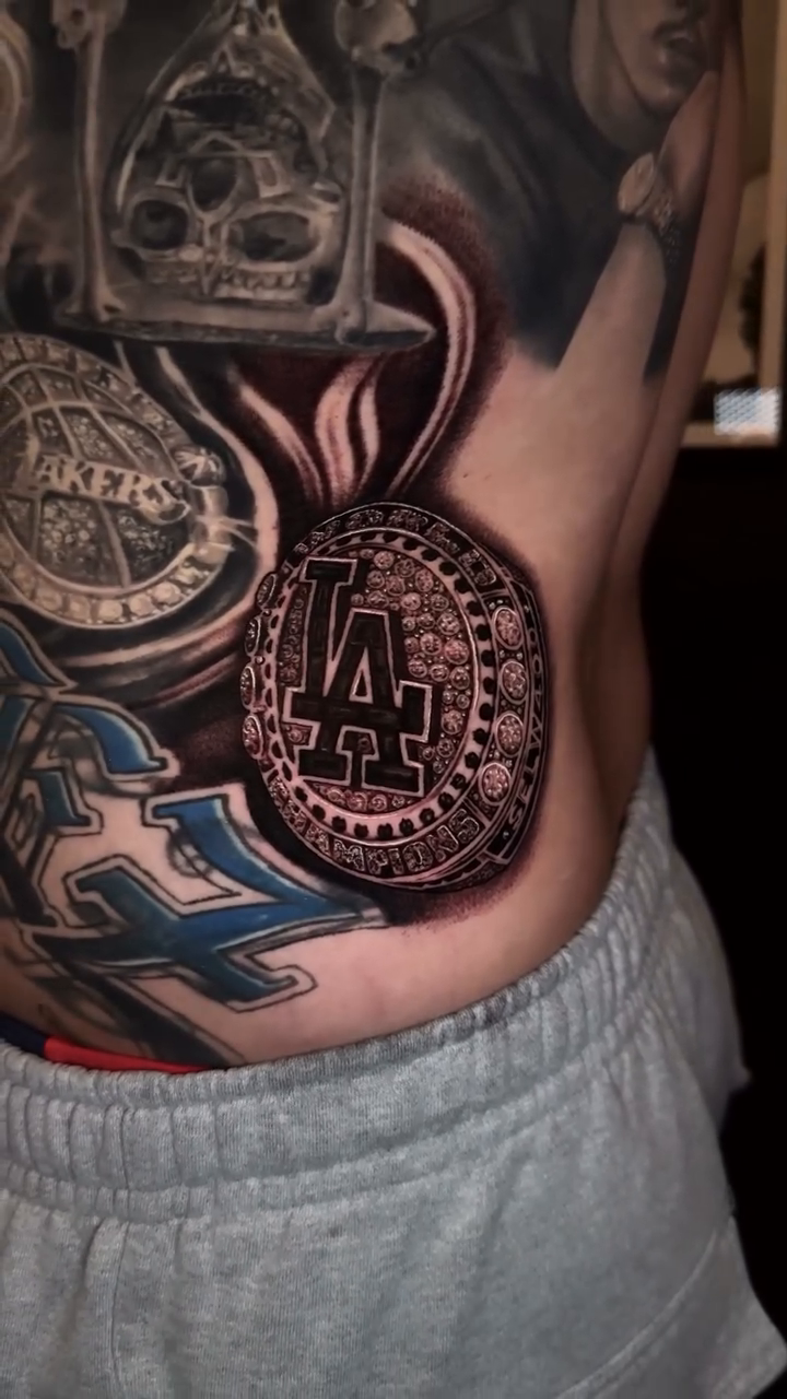 Medals with LA logo Chicano tattoo on the torso by Christian
