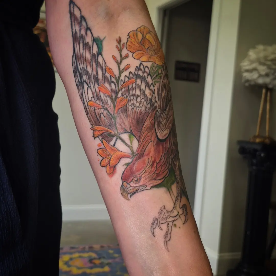 Bird and flowers realism tattoo on the forearm by Lydia Kiley