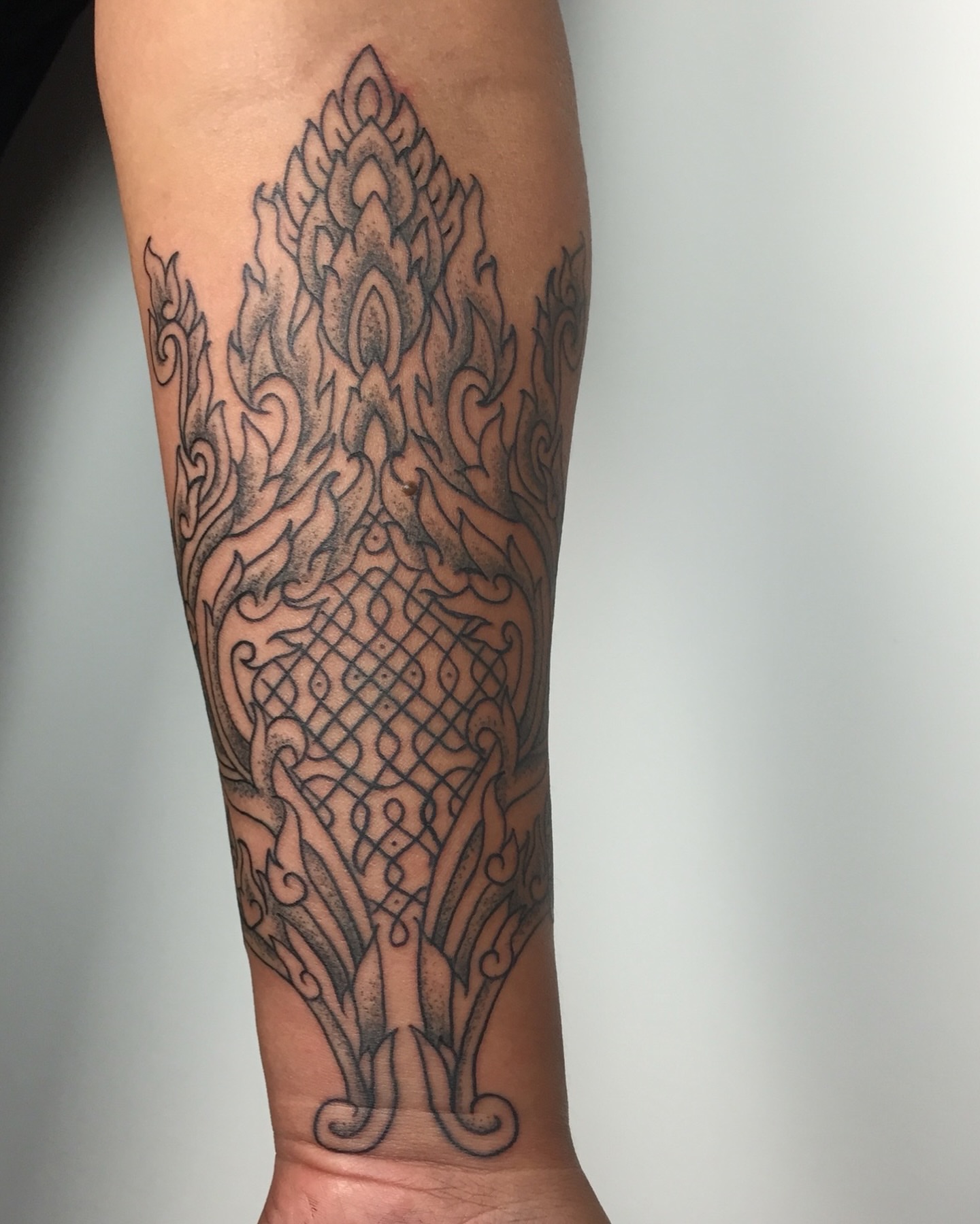 Flame geometric tattoo on the forearm by Dave Rodriguez