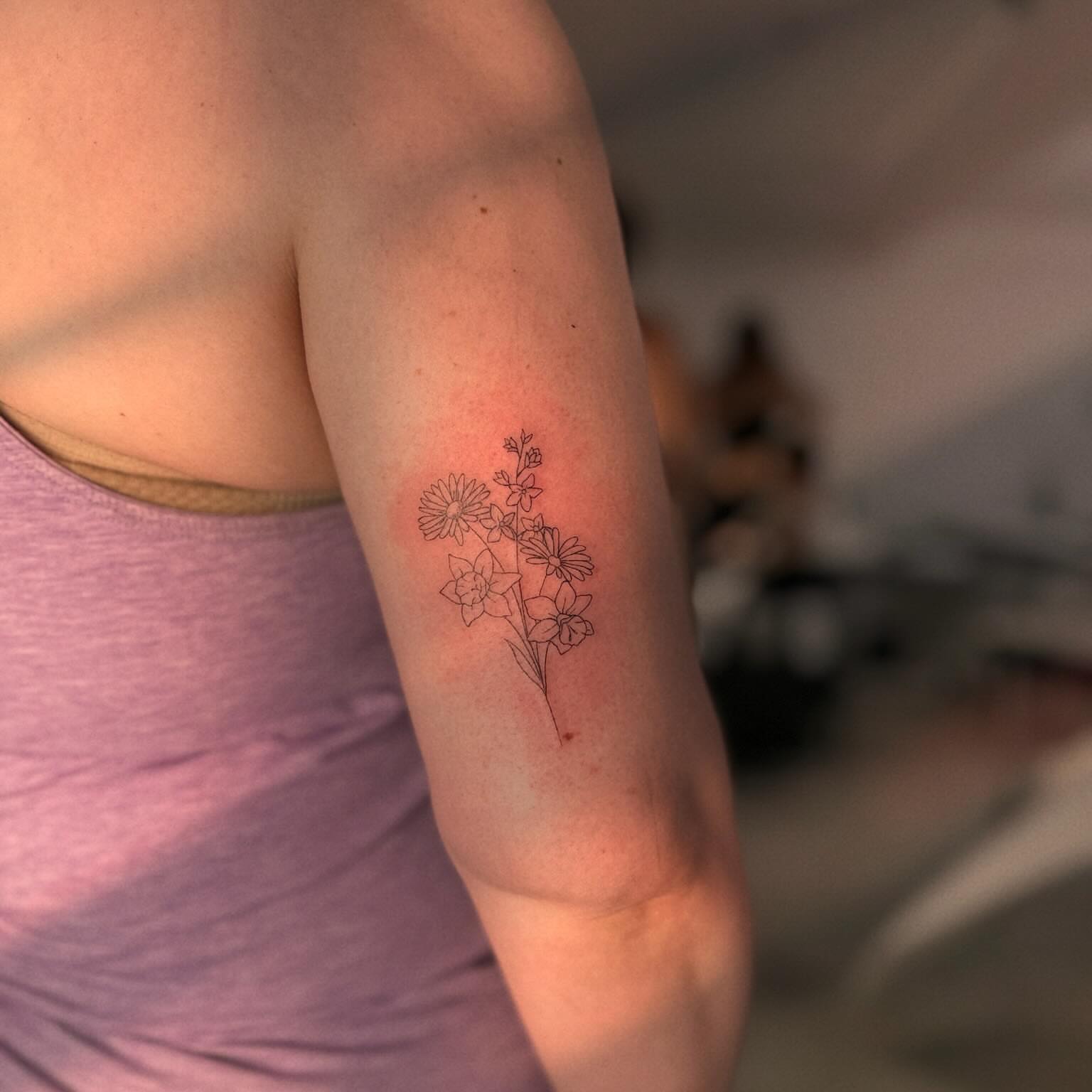 Floral arrangement fine line tattoo on the forearm by Ellie