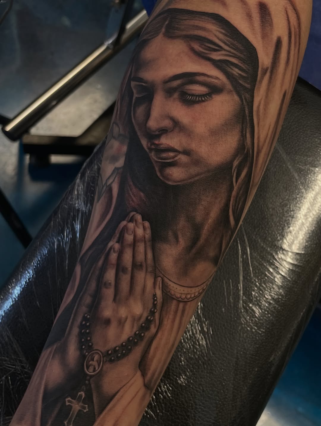 Praying woman with rosary Chicano tattoo on the forearm by Jennifer Garcia