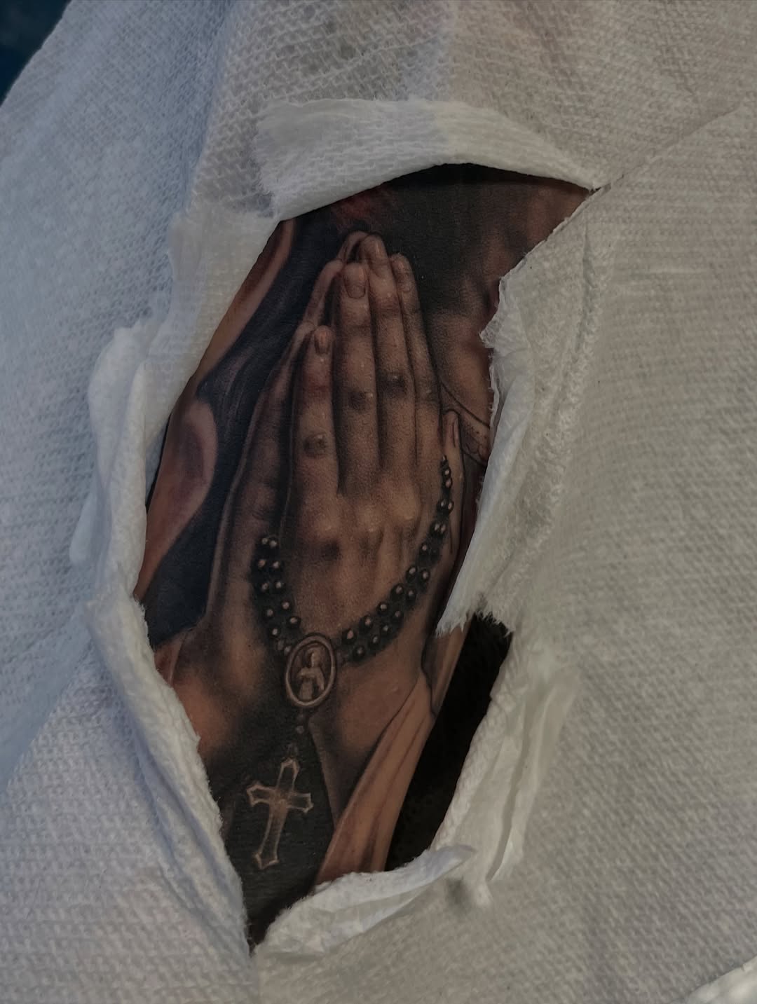 Praying hands with rosary Chicano tattoo on the hand by Jennifer Garcia