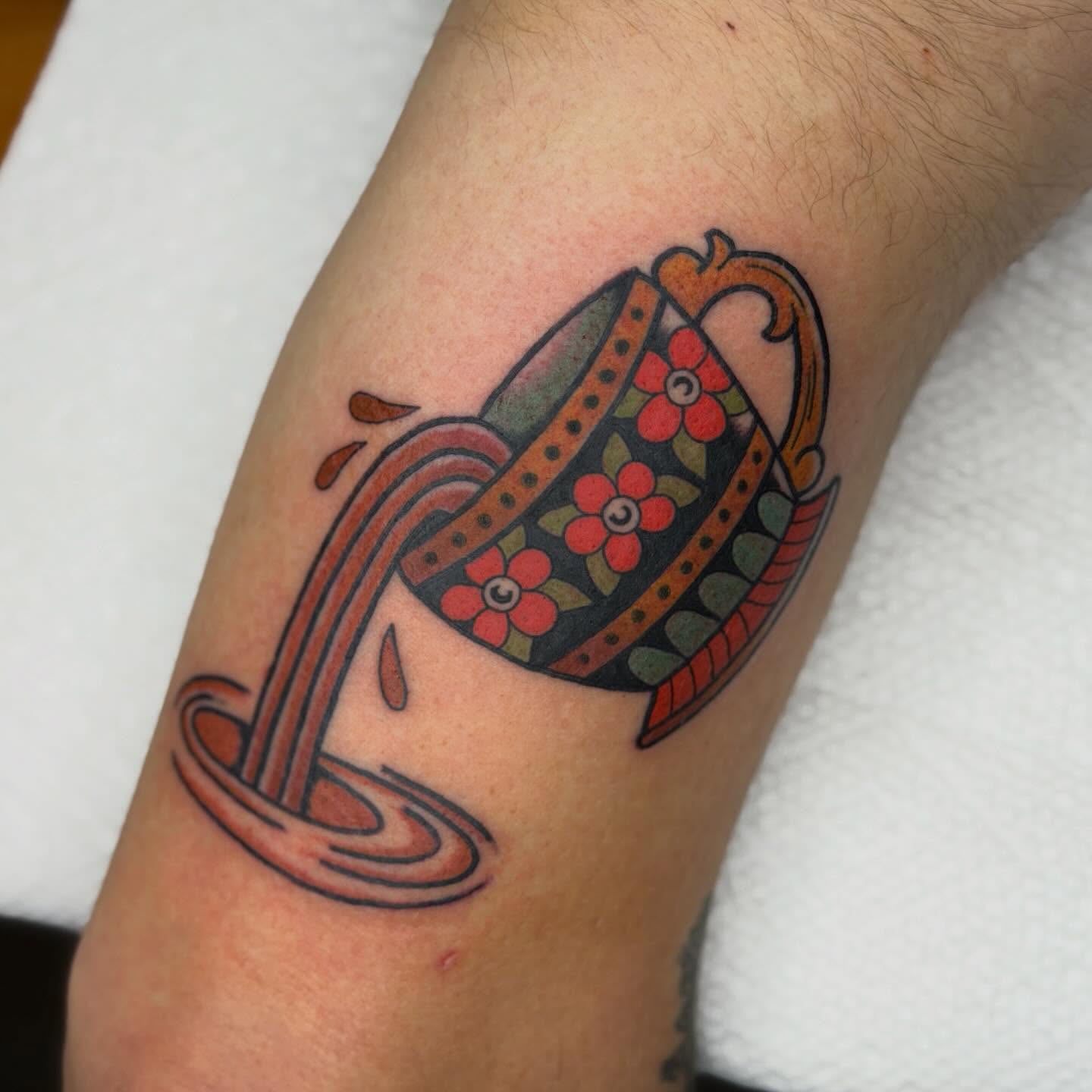 Teacup and tea American traditional tattoo on the forearm by Jenna Szerszen-Wynn ๐