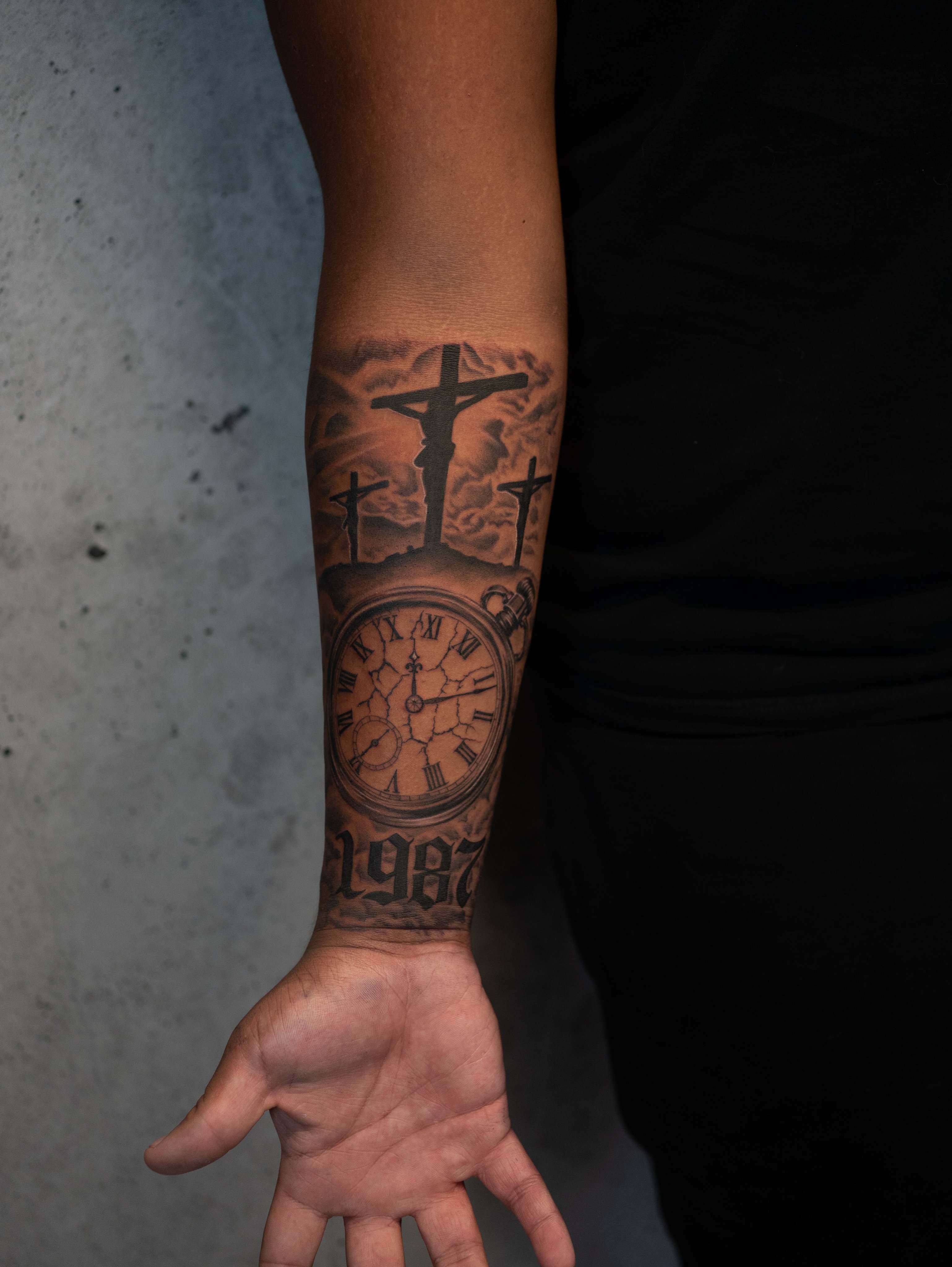Religious clock realism tattoo on the forearm by Damon Valdez