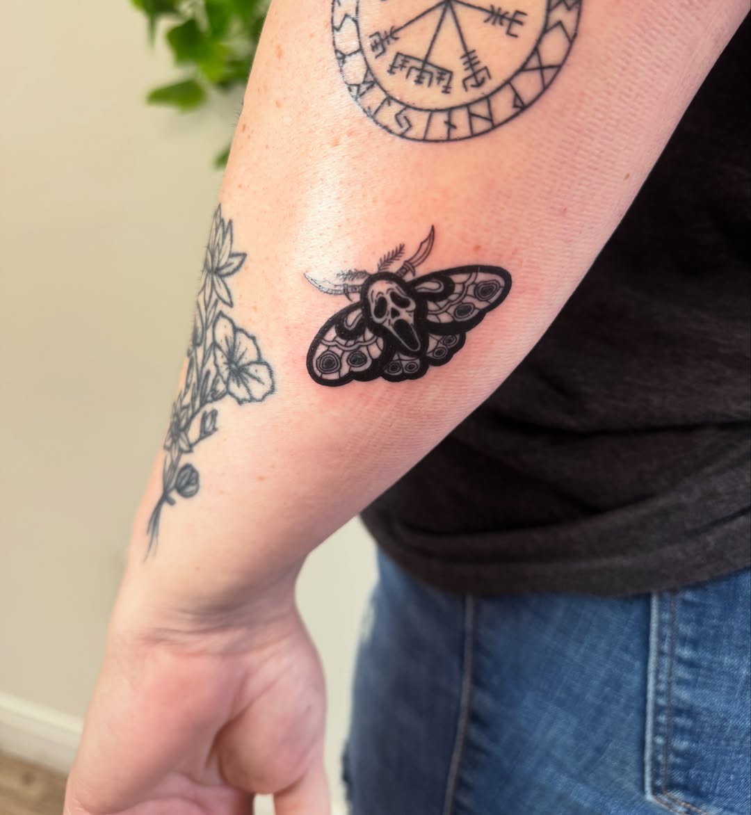 Moth black and grey tattoo on the forearm by Angela Nery, South Jordan, Utah