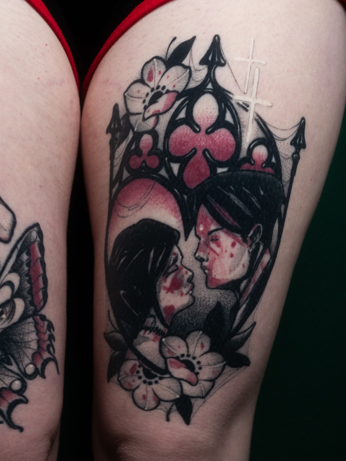 Kissing couple realism tattoo on the thigh by Robert Graye
