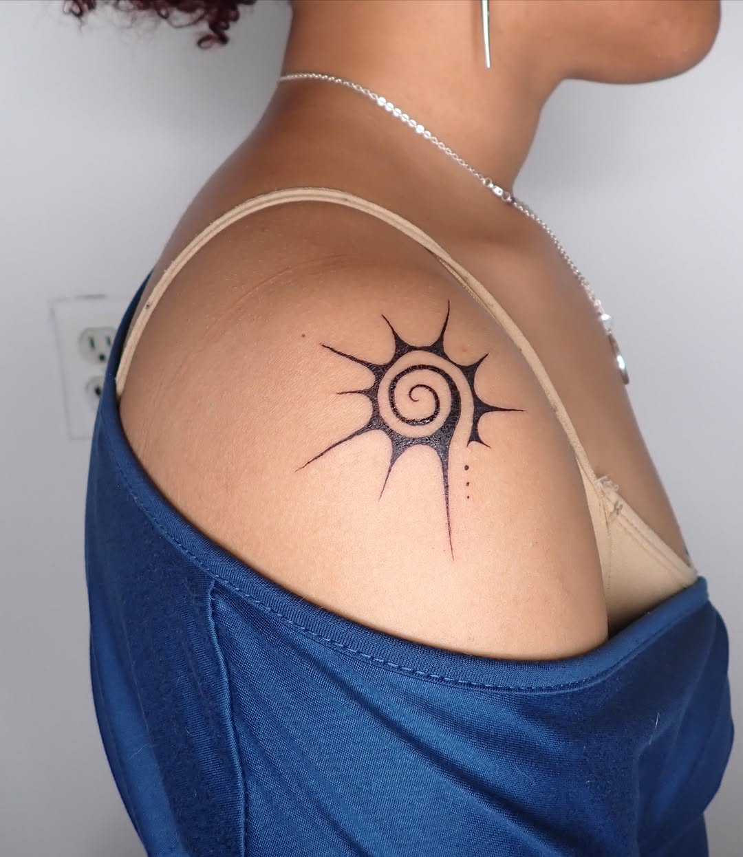 Sun spiral geometric tattoo on the shoulder by thalia