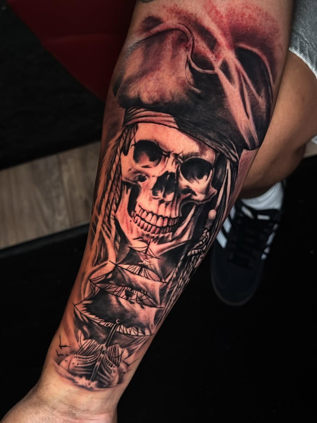 Pirate skull and ship realism tattoo on the forearm by Cedric Fleming