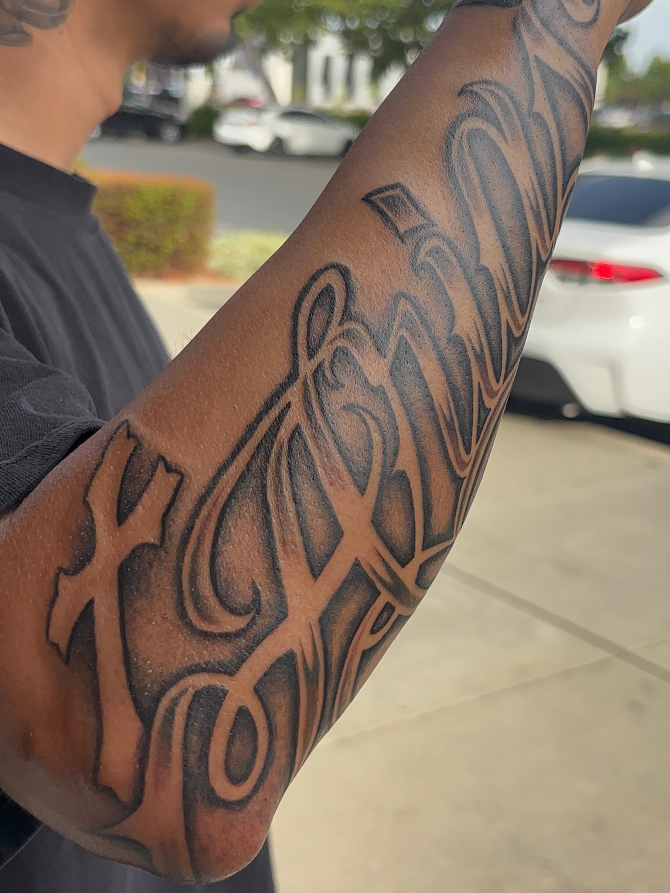 Script lettering lettering script tattoo on the forearm by Cristiano Ochoa, Elk Grove, California