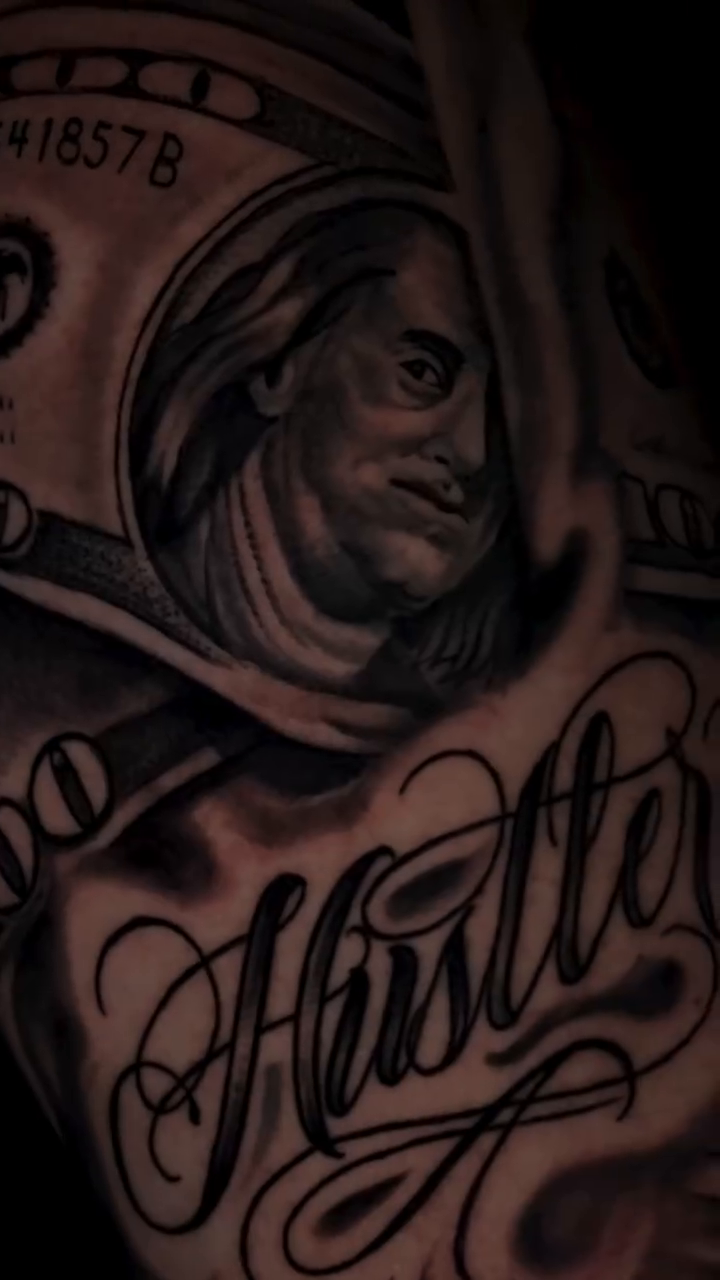 Money and Hustle Chicano tattoo on the shoulder by Henry Fuentes