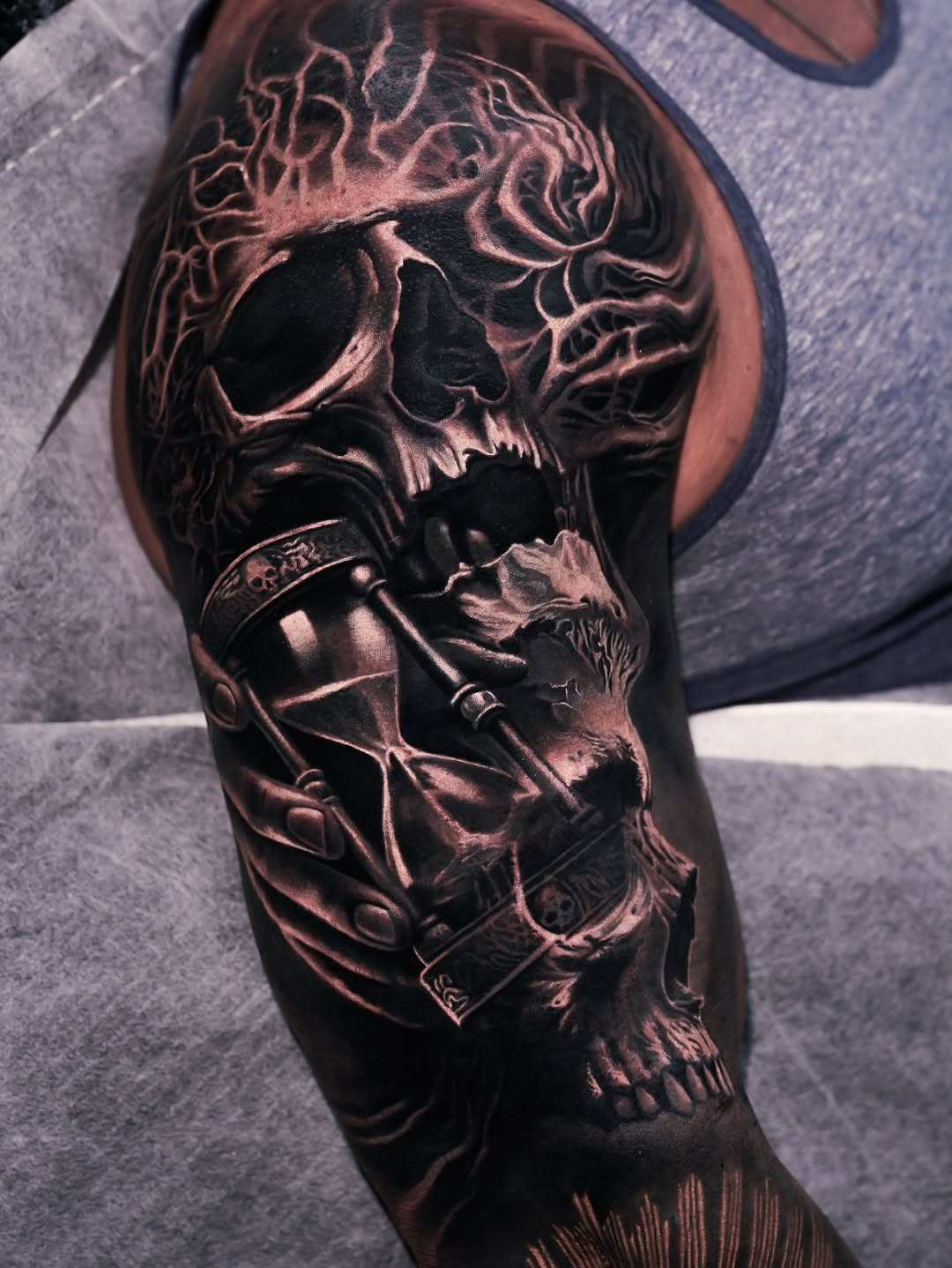 Skull and hourglass dark art tattoo on the forearm by George Lange