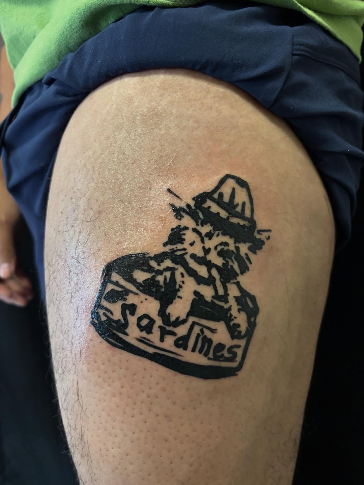 Sardine can black and grey tattoo on the thigh by Pres!