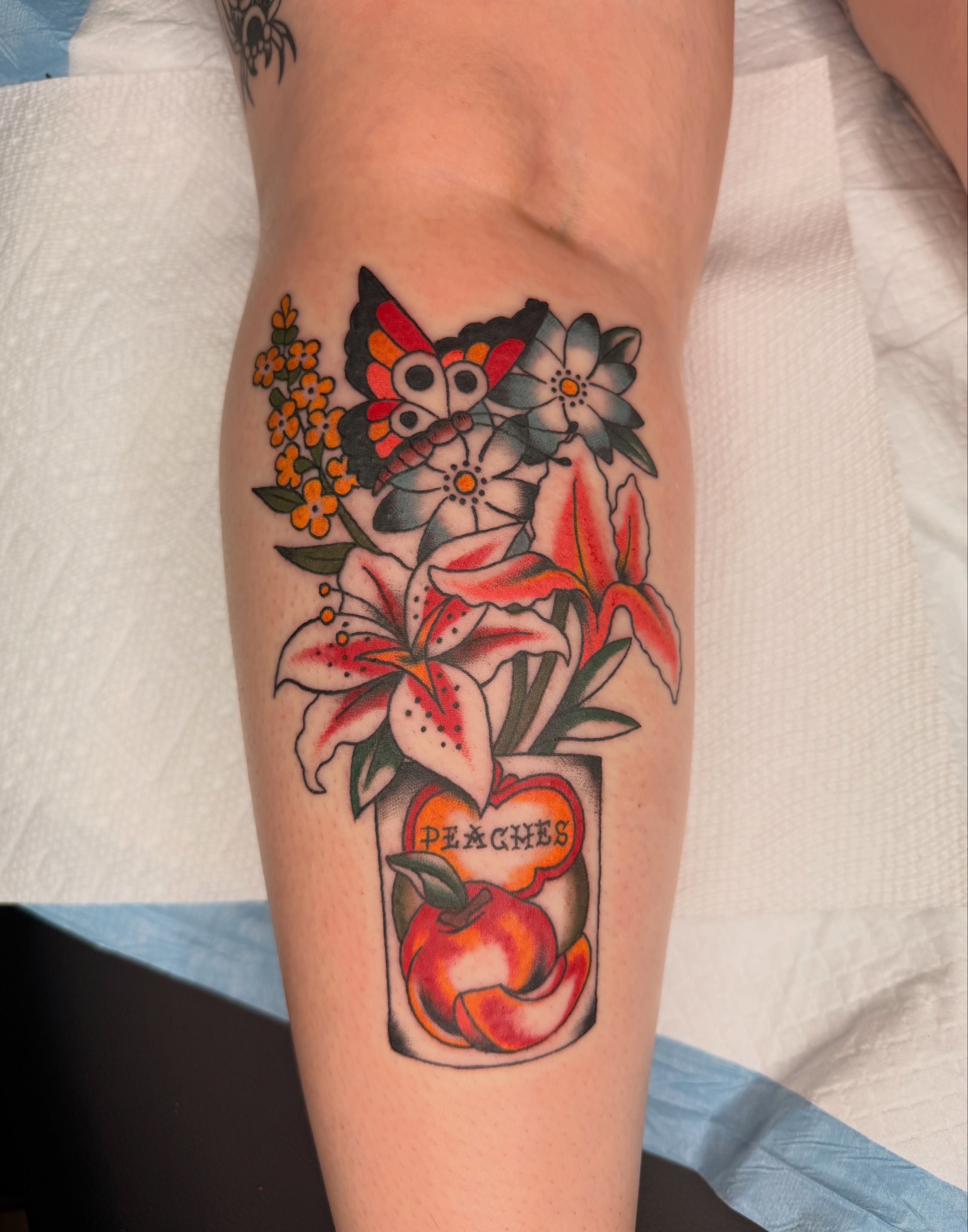 Peaches and flowers American traditional tattoo on the forearm by Emma Fox Tattoo
