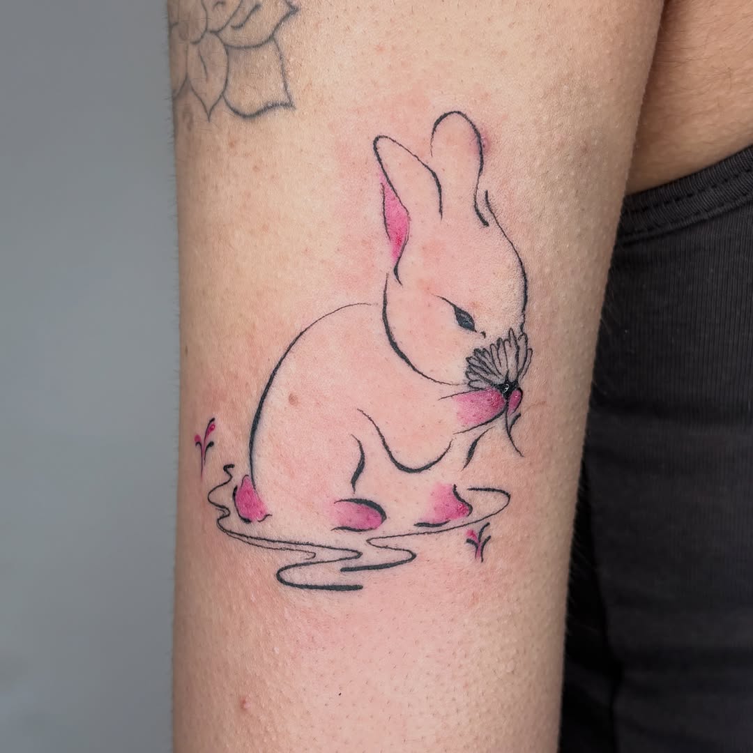 Bunny with flower fine line tattoo on the forearm by *:・kelly✧*:・゚