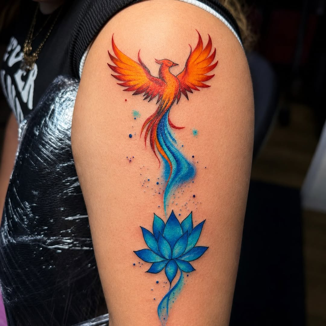 Phoenix and lotus flower watercolor tattoo on the upper arm by PMU Artist