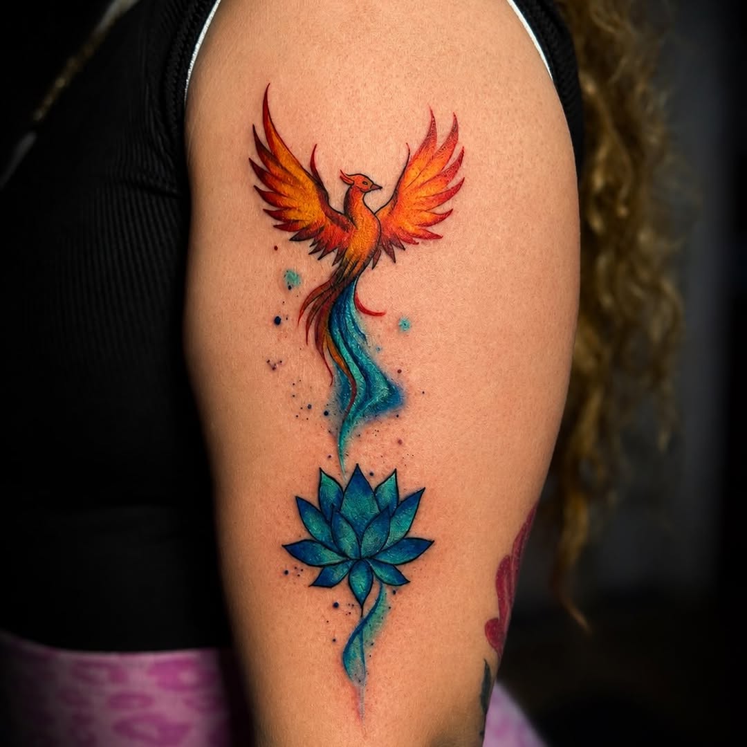 Phoenix and lotus flower watercolor tattoo on the upper arm by PMU Artist