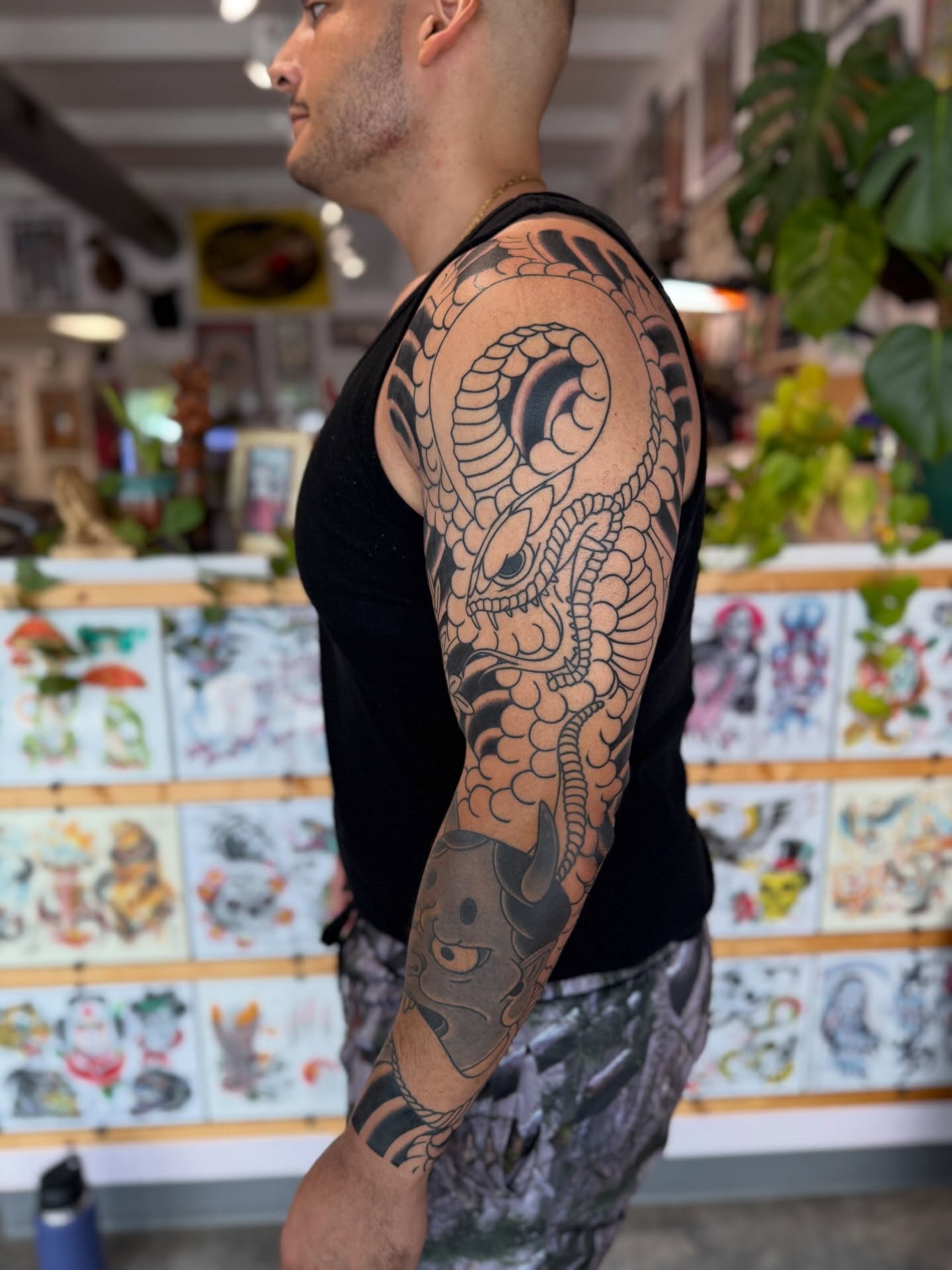 Dragon American traditional tattoo on the upper arm by Jason Eisenberg