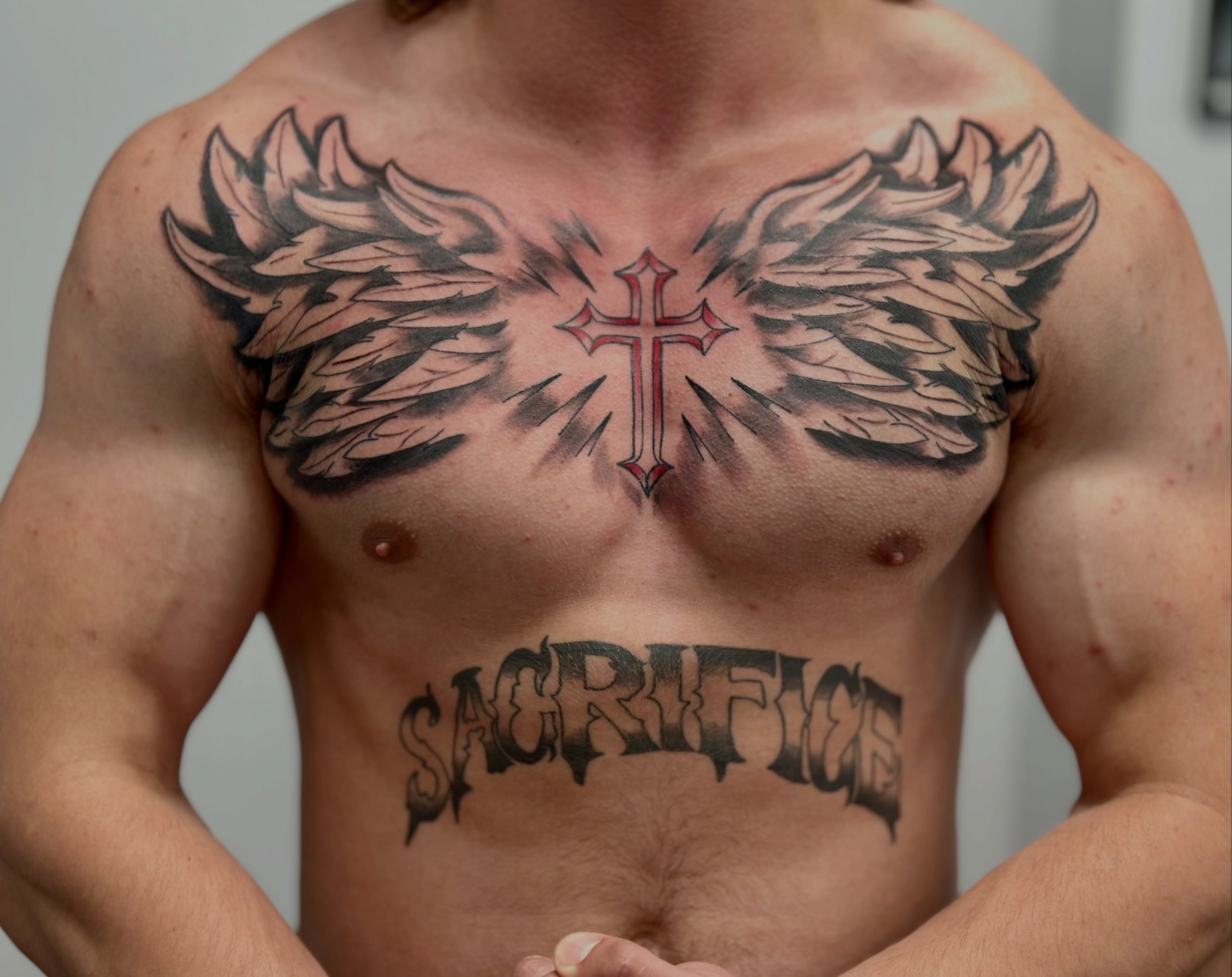 Cross with wings black and grey tattoo on the chest by AJ