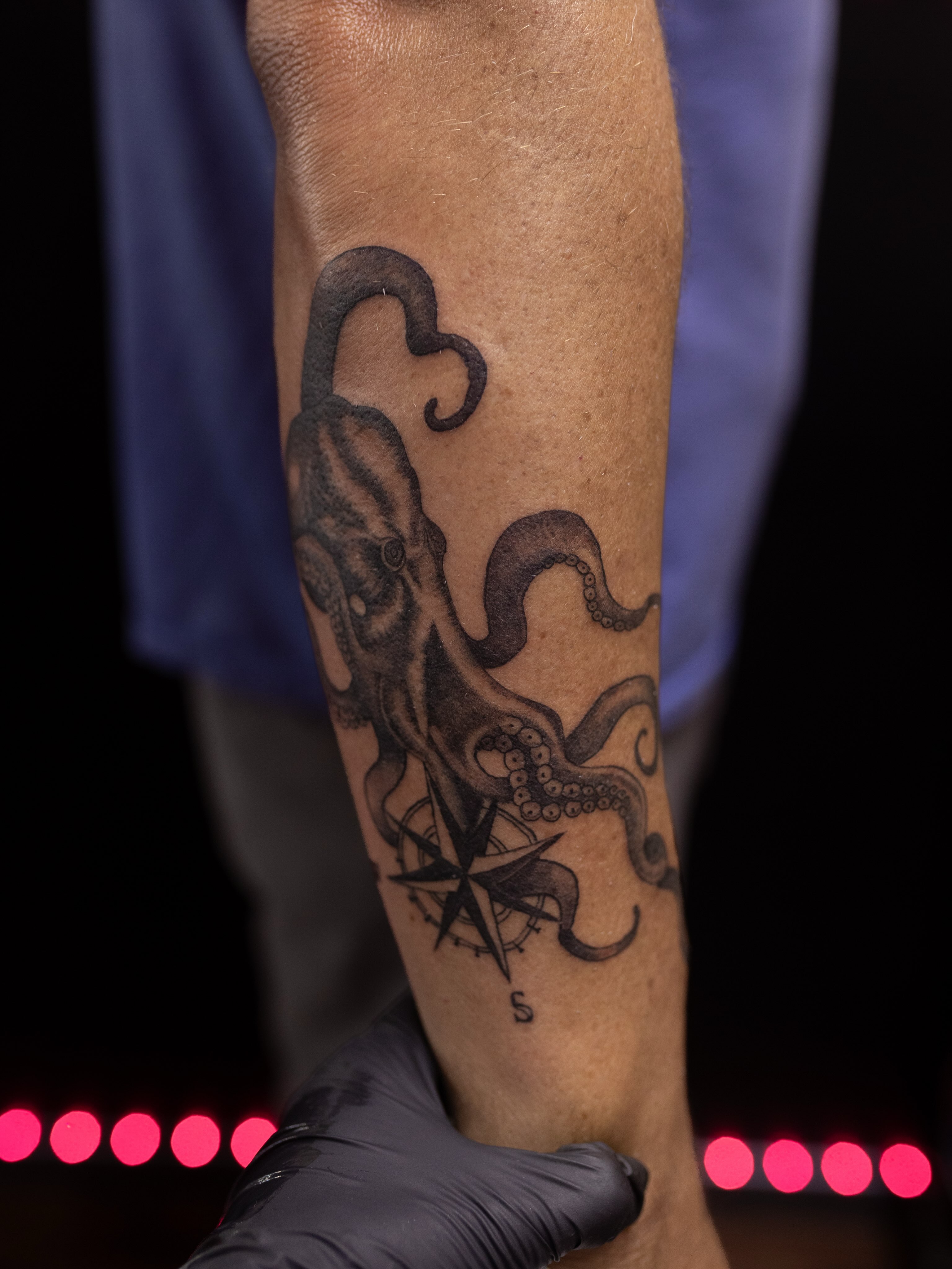 Octopus and compass realism tattoo on the forearm by Kelsie