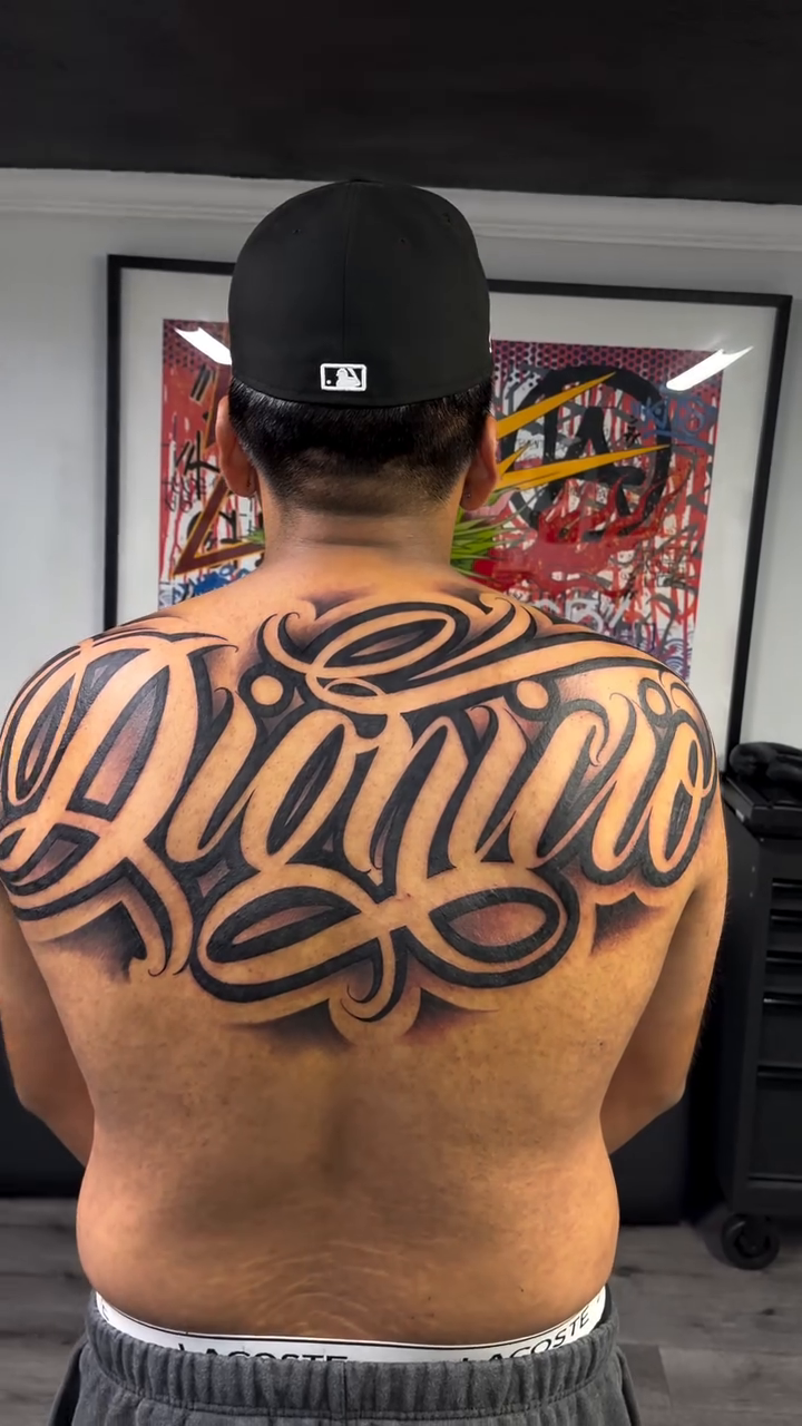 Tattoo by @rockyg_inkz — lettering_script, chicano