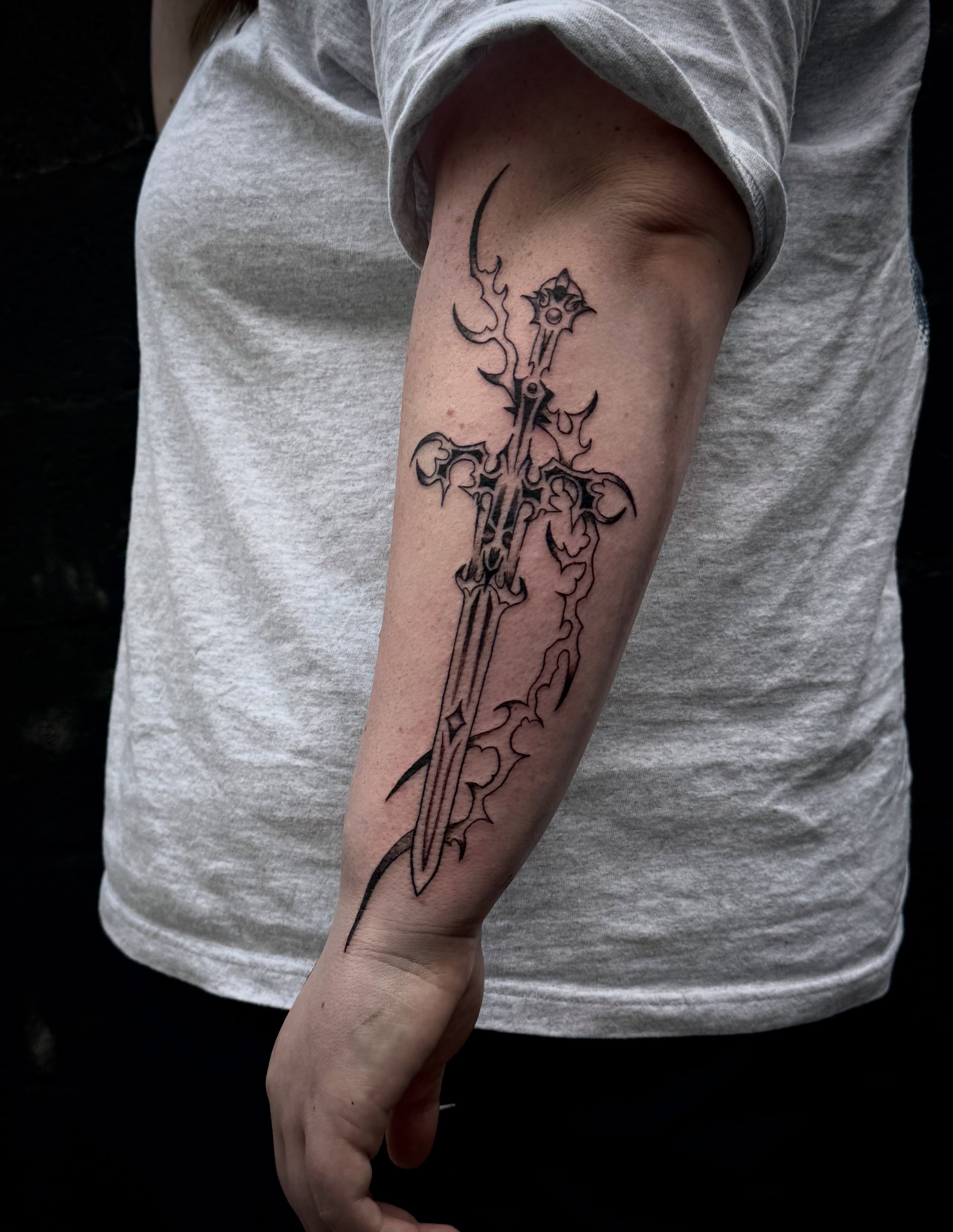 Sword black and grey tattoo on the forearm by dev