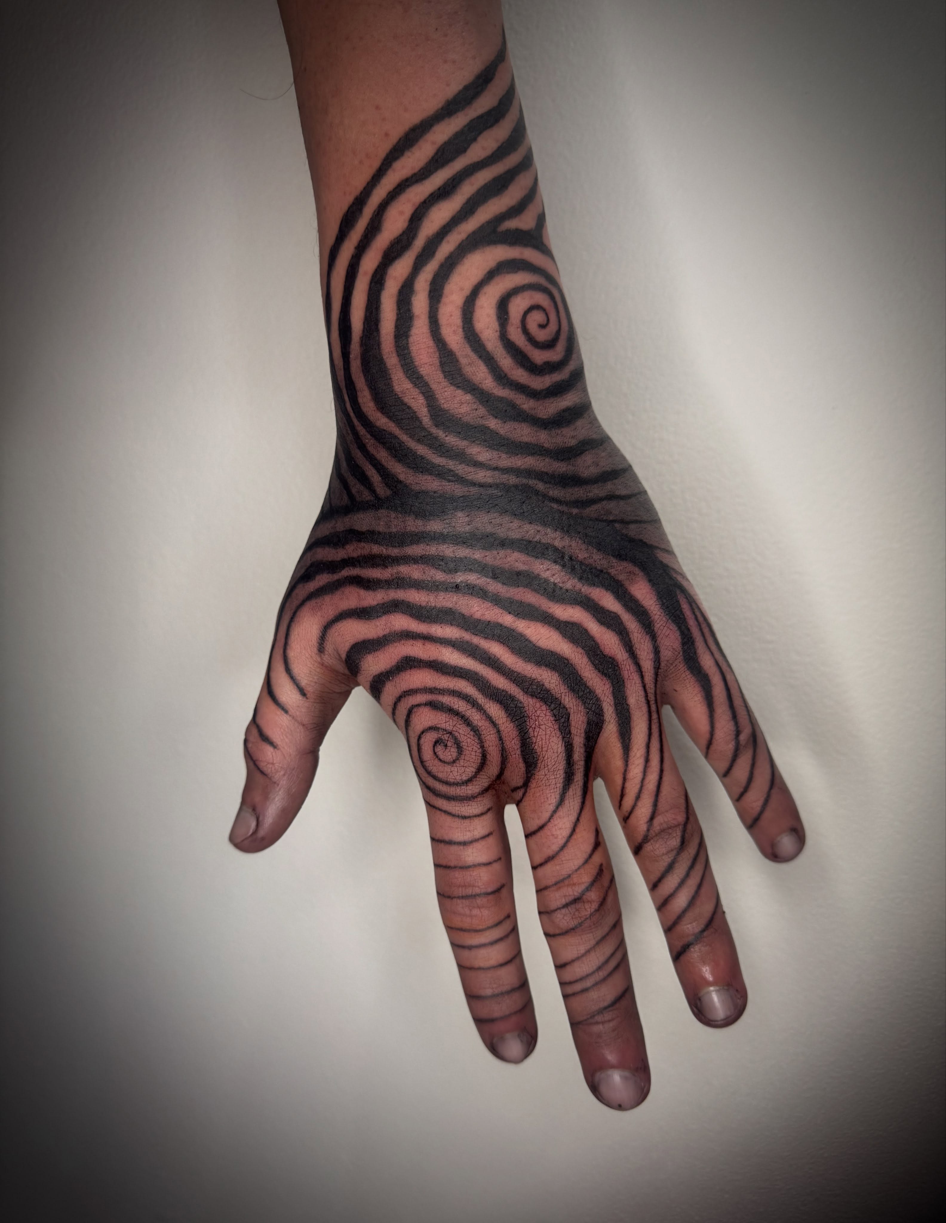 Spiral pattern geometric tattoo on the hand by dev