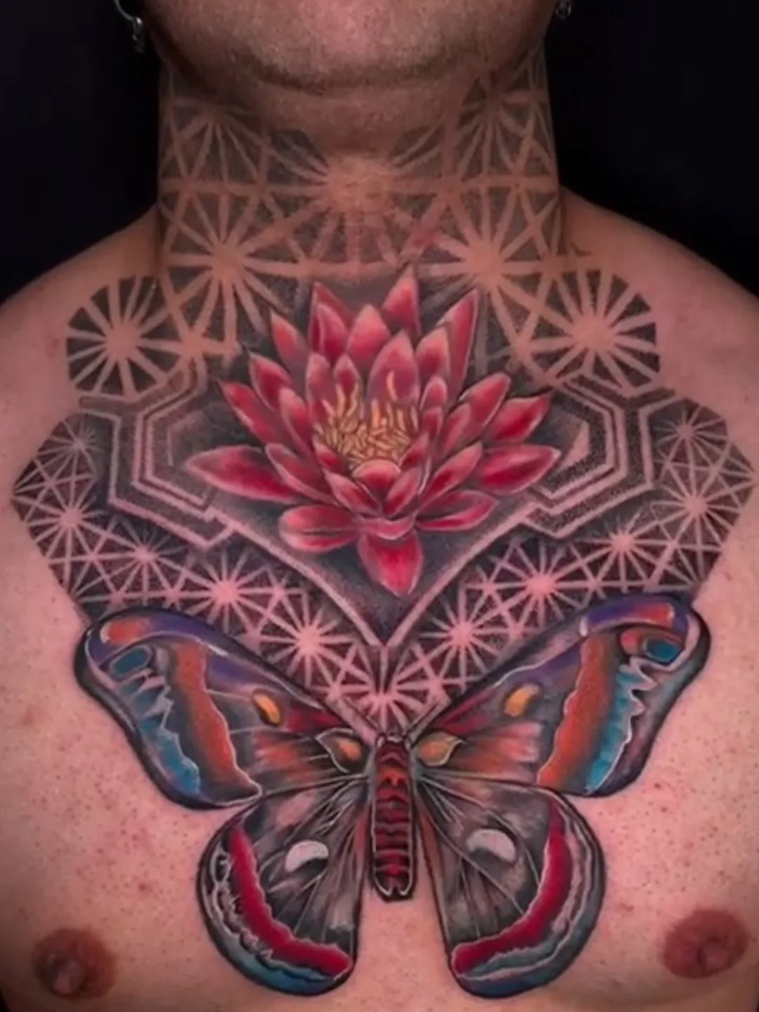 Water lily and butterfly geometric tattoo on the chest by William Gualteros