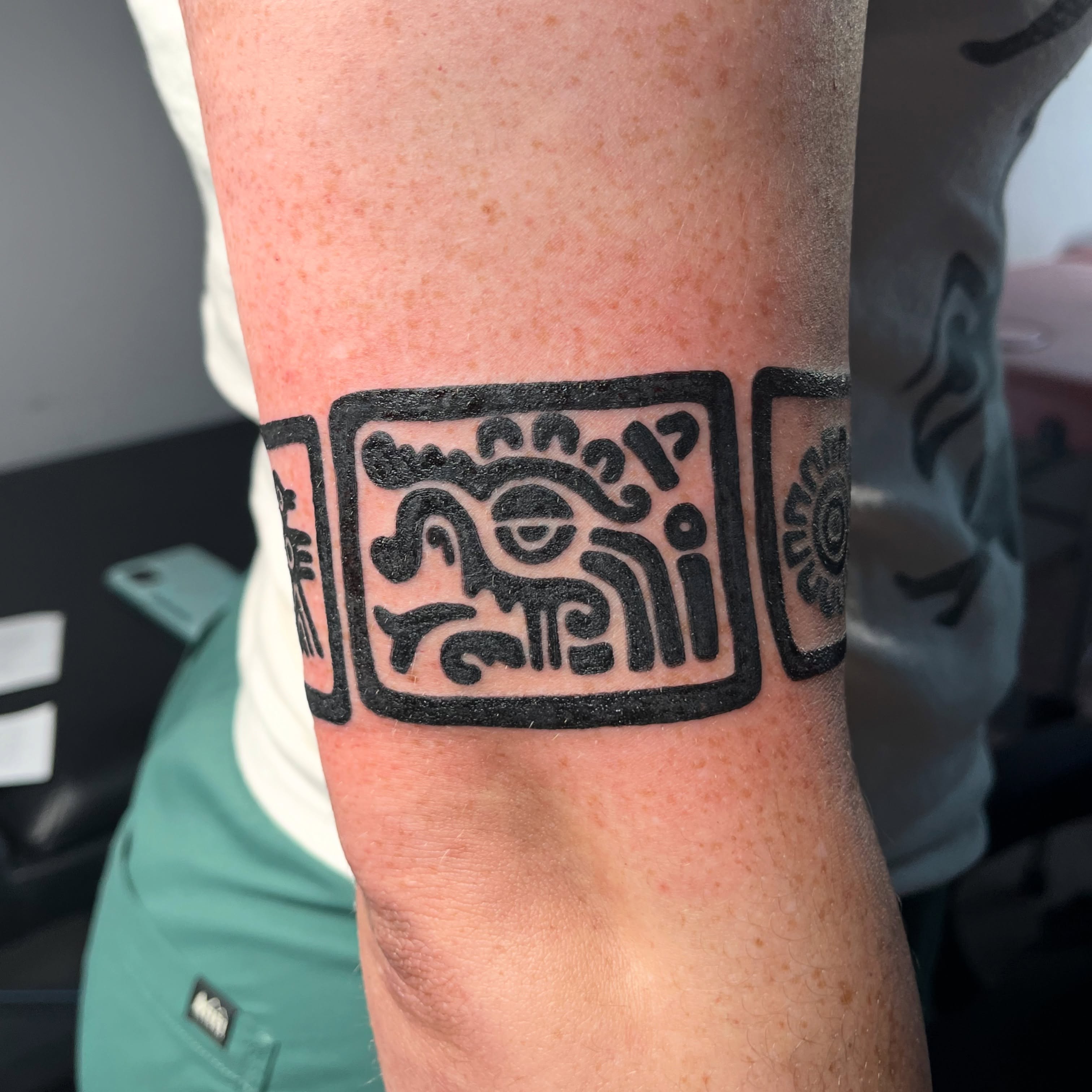Sun and face black and grey tattoo on the forearm by christina diaz