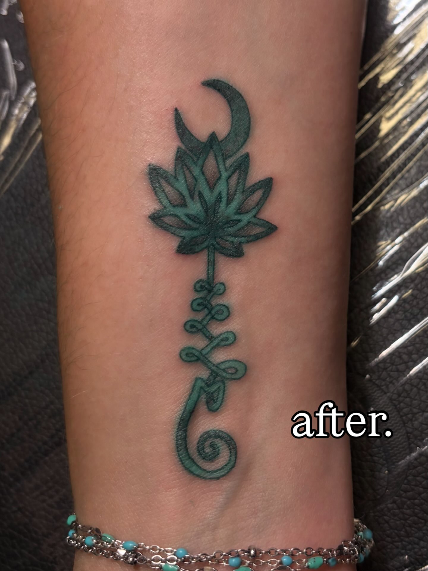Lotus flower with crescent moon geometric tattoo on the forearm by Melissa
