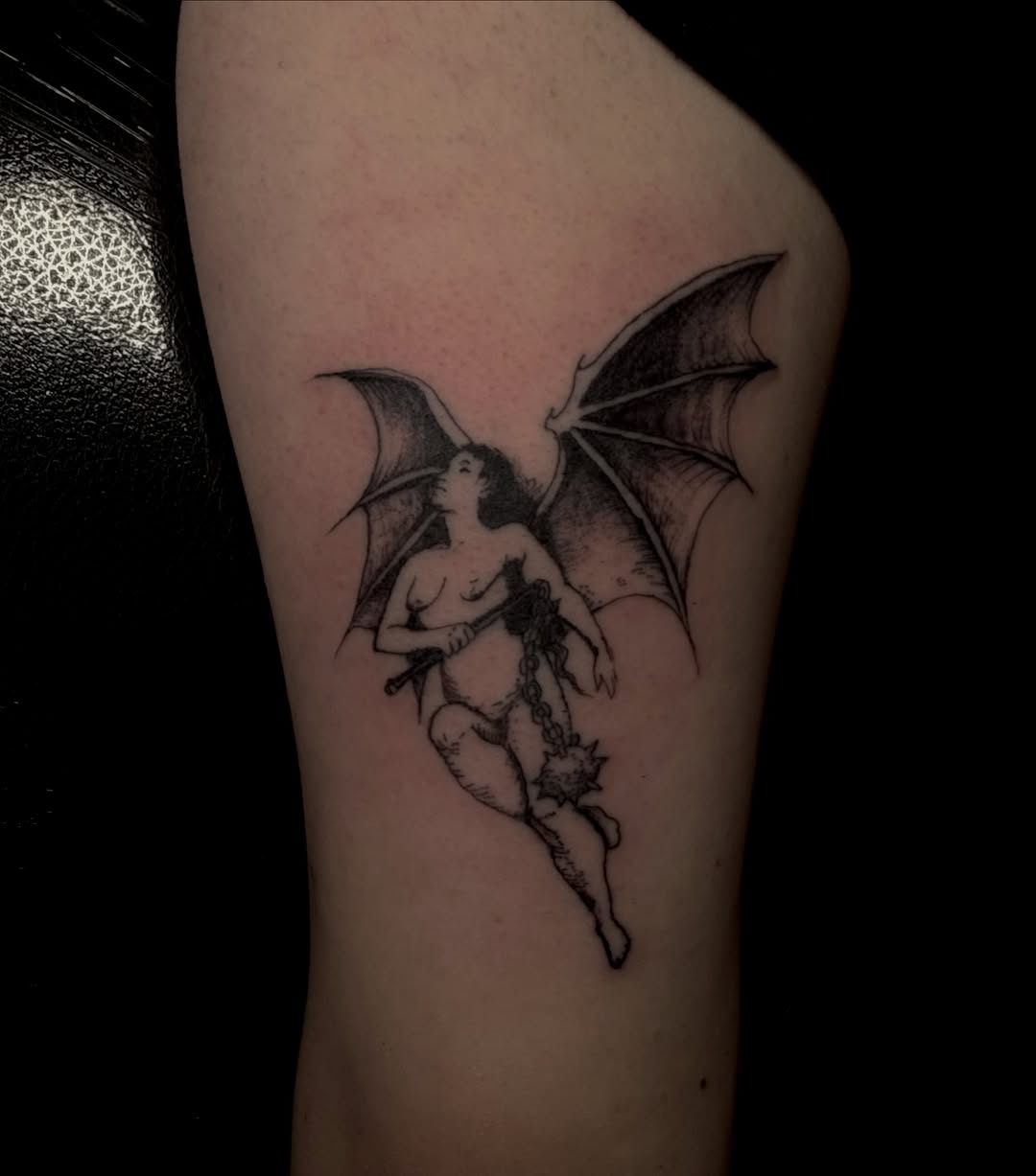 Winged demoness with mace realism tattoo on the thigh by Jordan Sandoval
