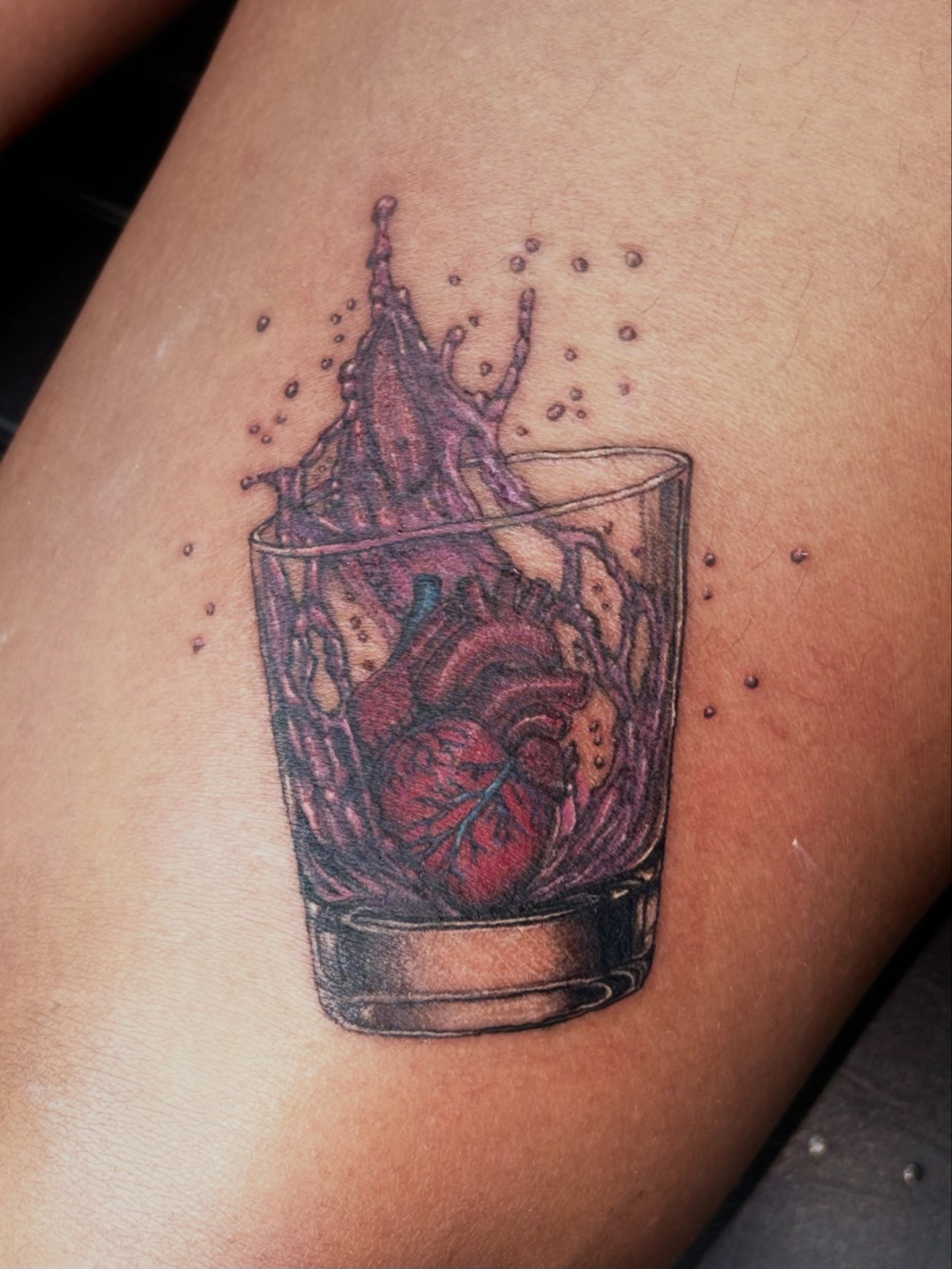 Heart in glass realism tattoo on the thigh by 𝔾𝔥𝓸ş𝔱