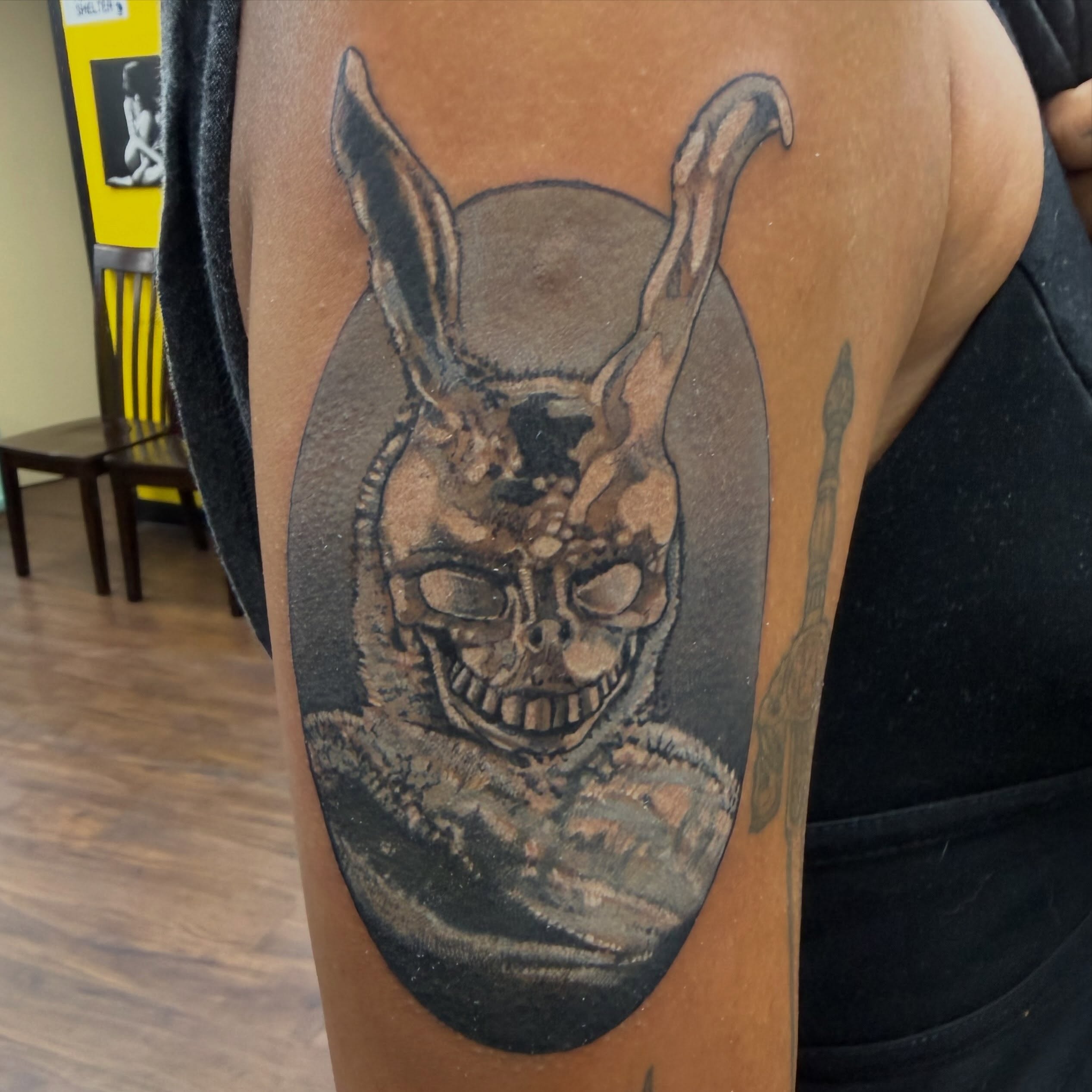 Skull with rabbit ears dark realism tattoo on the thigh by Aaron Hassler, Nashville, Tennessee