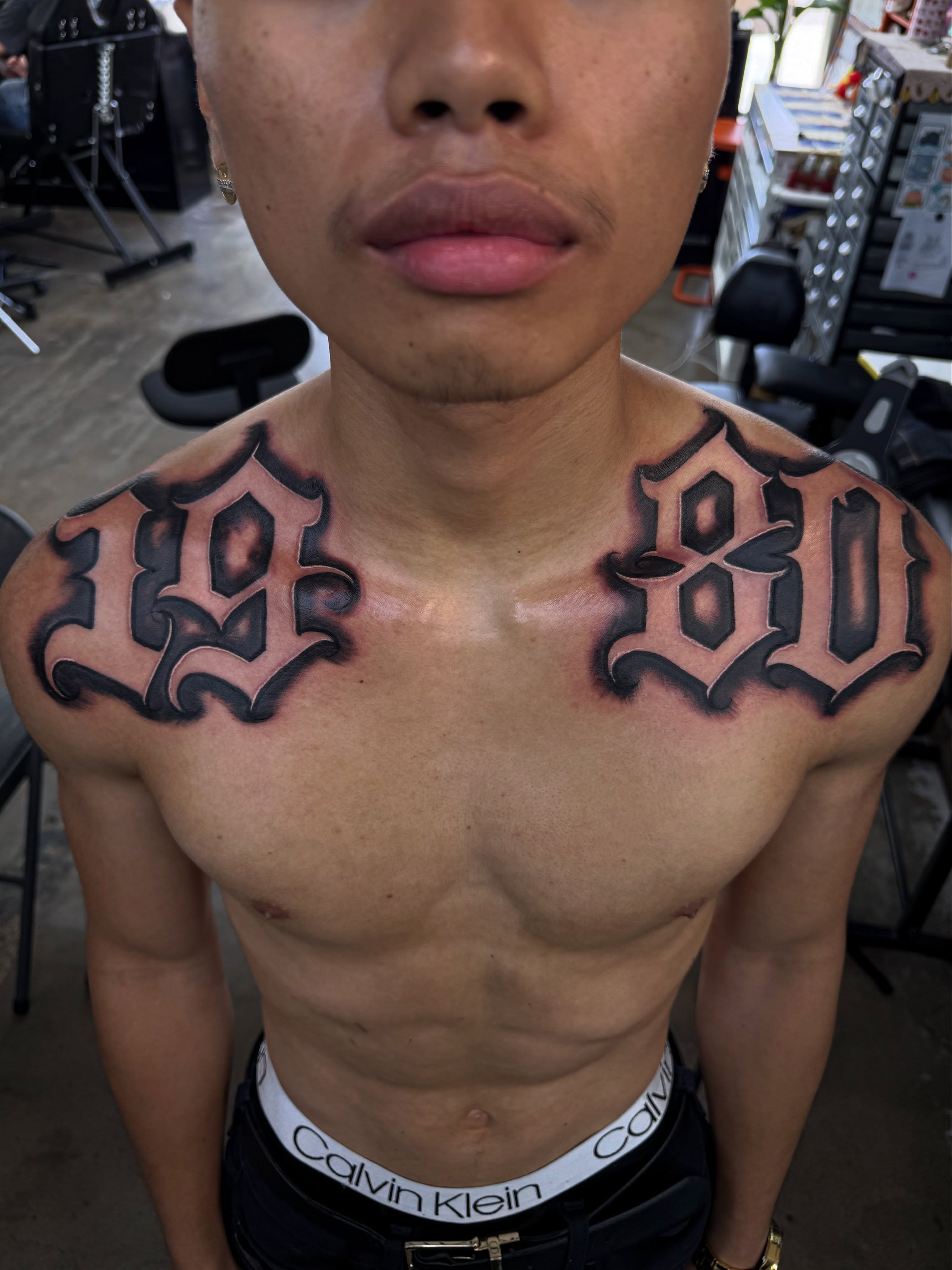 Numbers lettering script tattoo on the chest by @samg_tat2s, San Diego, California