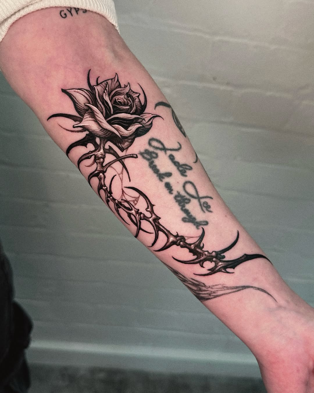 Tattoo by @doosik_tattoo โ black_and_grey, lettering_script